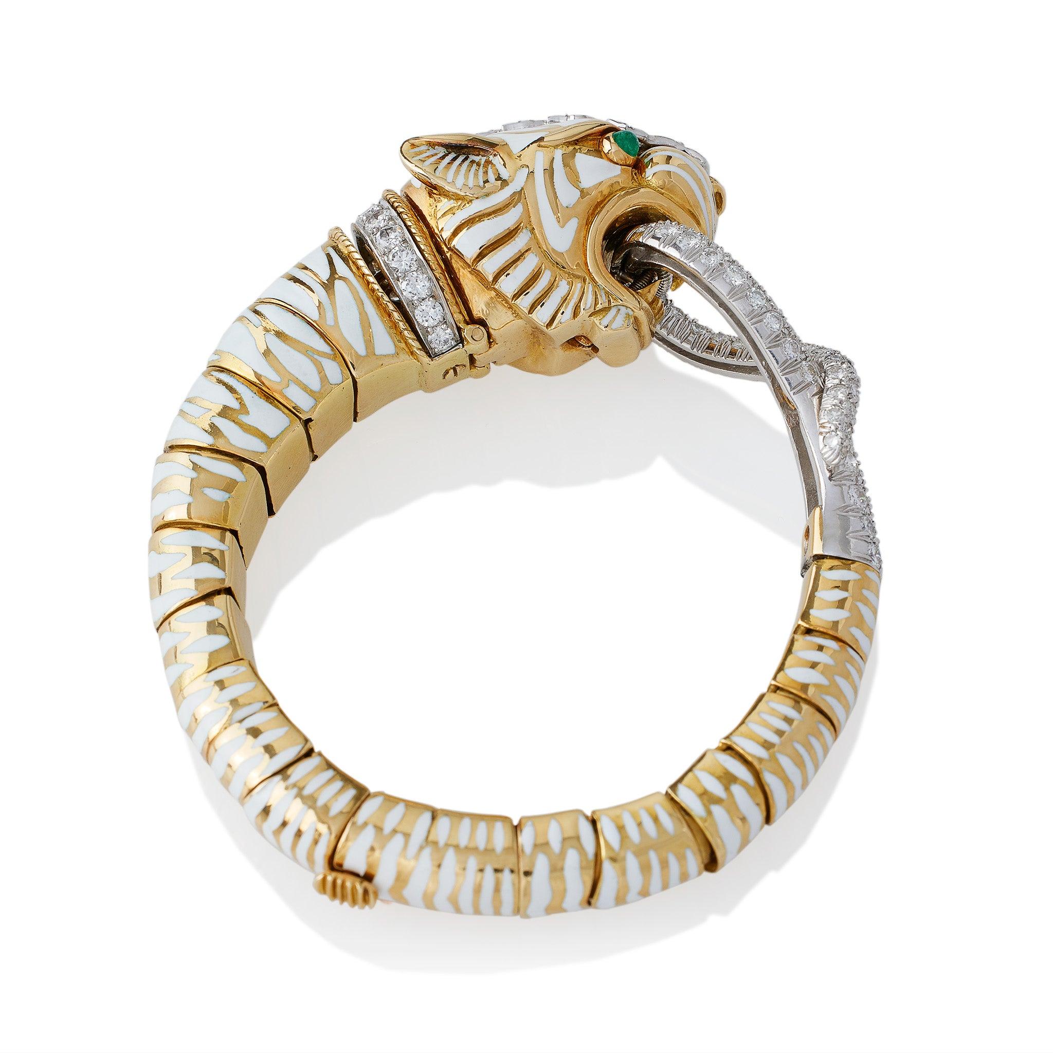 First created in this color scheme in 1967, this early David Webb enamel flexible tiger bangle bracelet is set with emeralds and over 5 carats of diamonds. A tiger with diamond blaze and collar, white champlevé enamel stripes and and cabochon