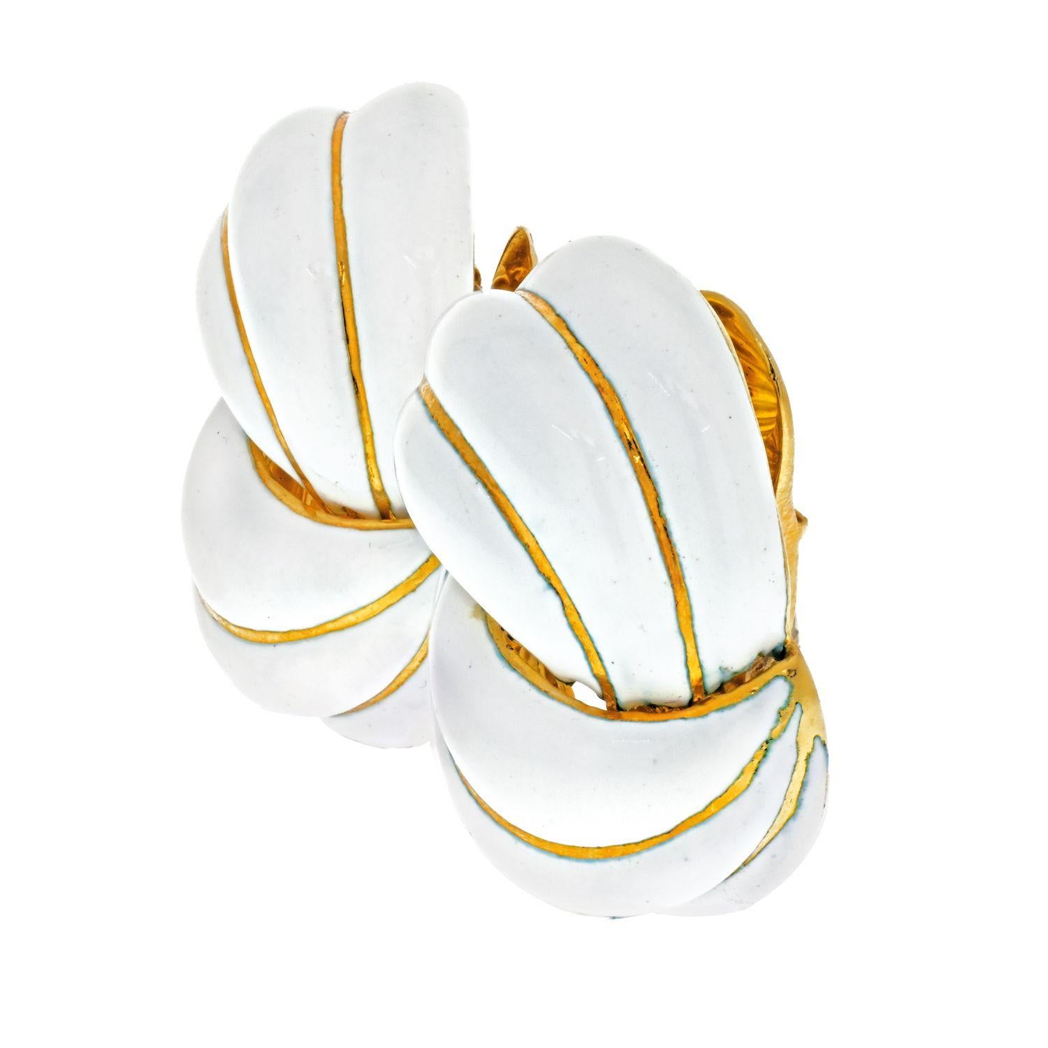 Elegant, fun and wearable all in one, these David Webb swirl design clip-on earrings are the classic 'day or night' style. Designed with striped white enamel and 18k yellow gold in an swirl, the huggie earrings weigh 32.8 grams and measure 1 1/8in.