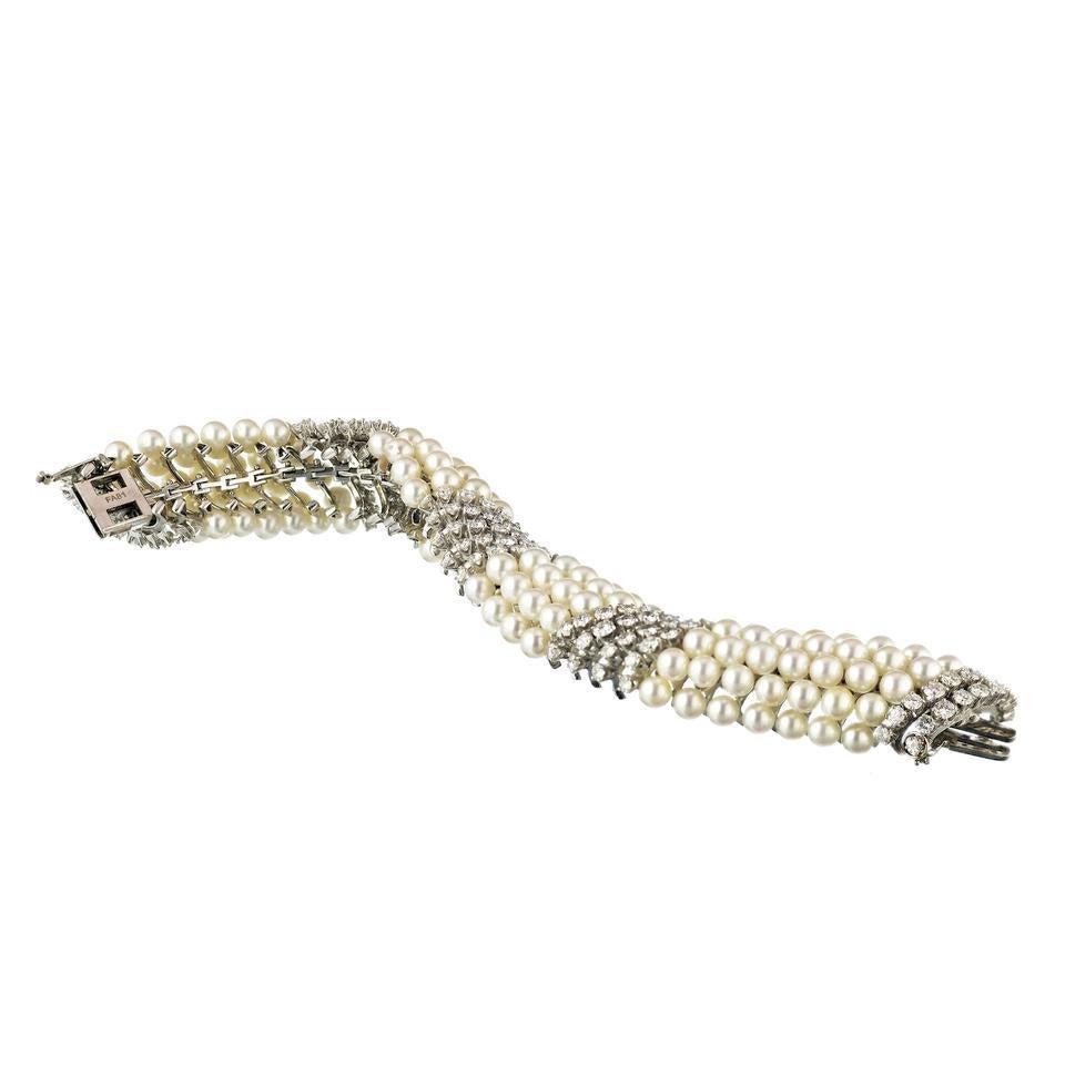 This beautiful diamond and multi-row pearl bracelet by David Webb is a truly spectacular gift. Its intricate design is crafted from 18k white gold and features alternating rows of gorgeous white pearls and brilliant diamonds. It's a timeless piece