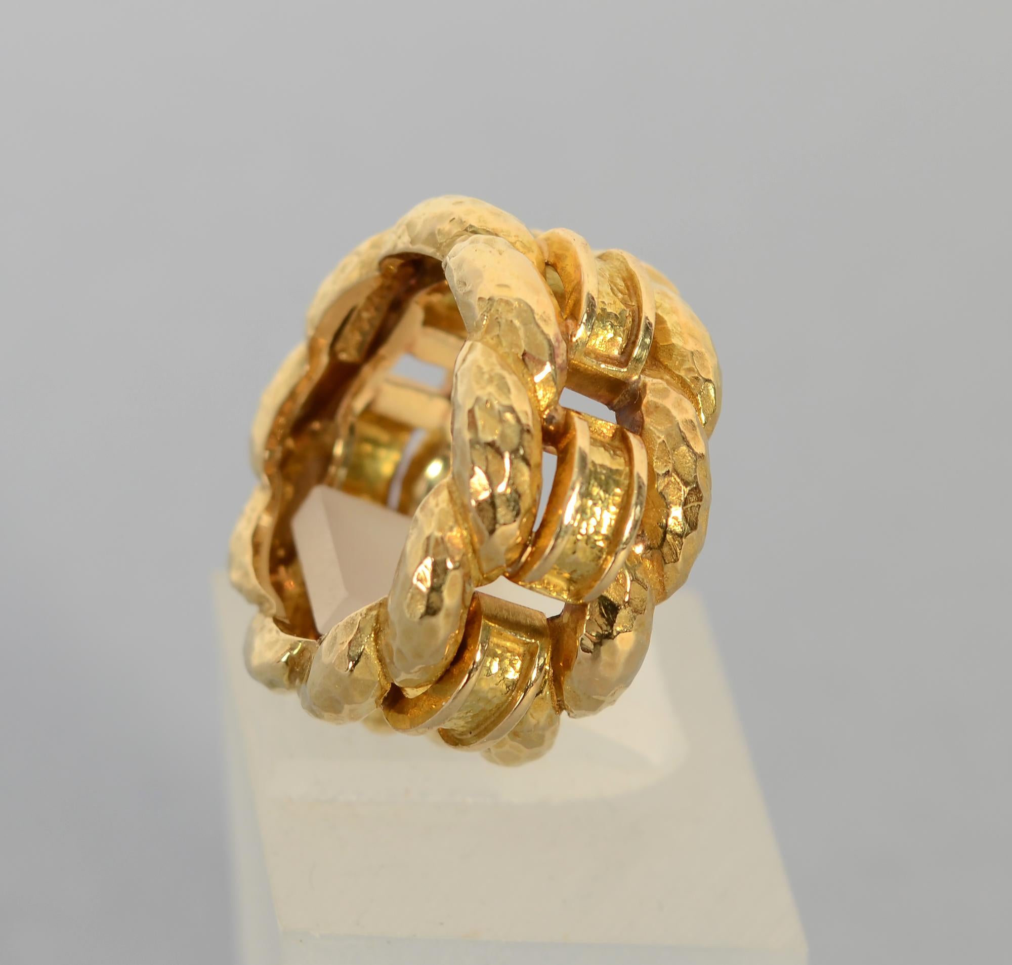 Beautifully made wide woven gold band by David Webb. The entire ring is hammered 18 karat gold. Twisted rope top and bottom flanks rectangular arched links.
The ring is half an inch wide. It is size 6. A jeweler can put balls gold inside to make it