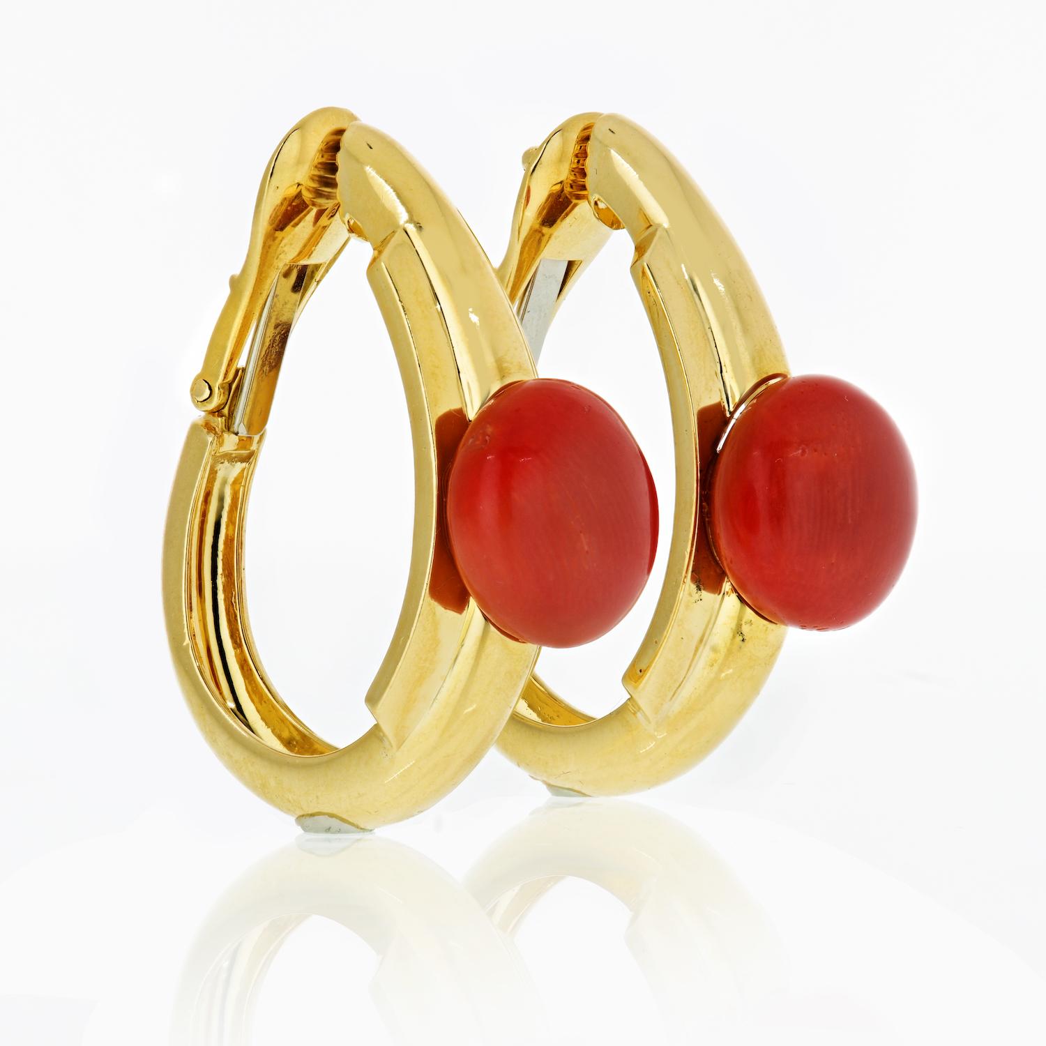 Designed as high polished hoop earrings these easy to wear David Webb clips have a nice cabochon bright coral atop of each hoop. 

Just about 1 inch long these earrings are your everyday summer classic. 