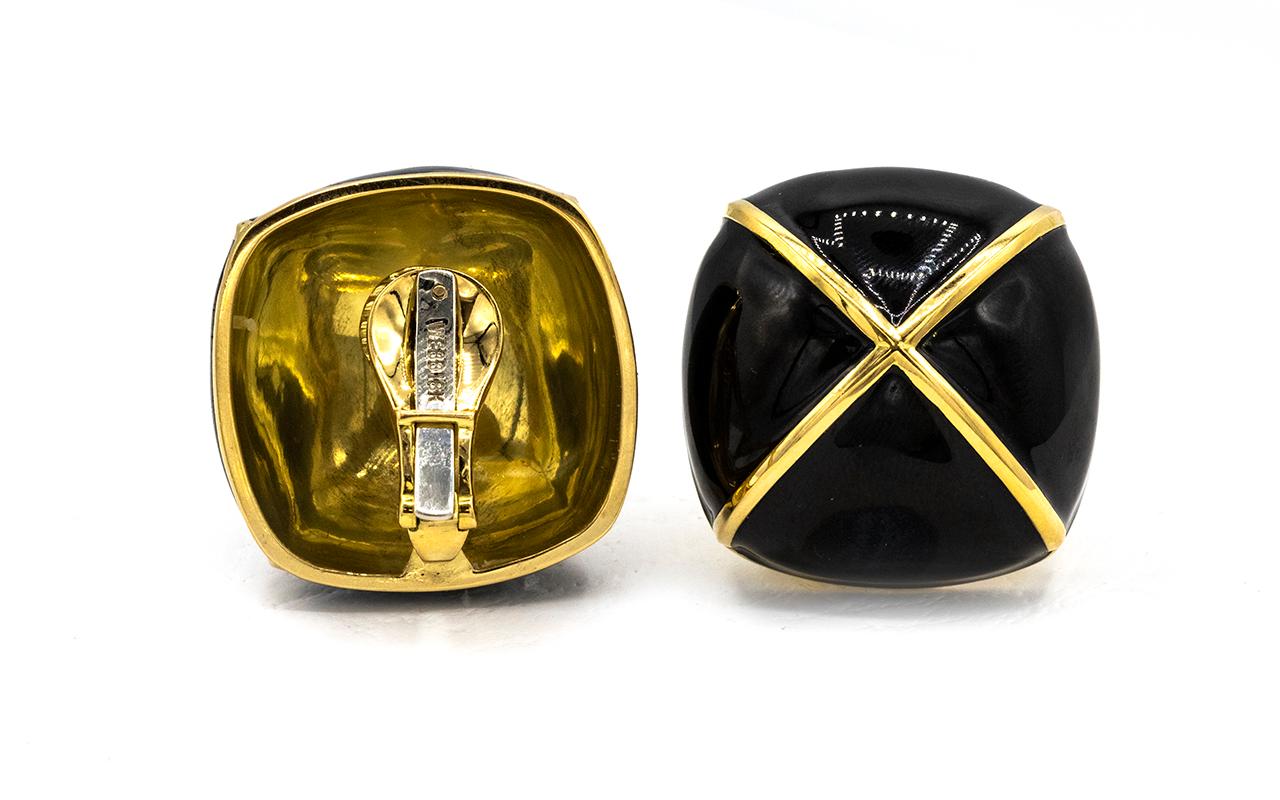 Experience the bold elegance of the David Webb Cushion-Shaped Black Enamel Gold Detail Clip Earrings, a striking pair that encapsulates the designer's iconic style and mastery in craftsmanship. Crafted in luxurious 18K yellow gold, these earrings