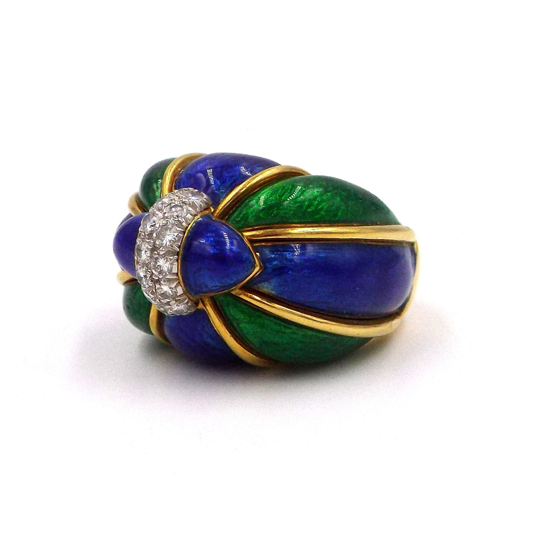 18 kt., striped with bombé panels of patterned blue and green enamel, topped by a platinum band set with 13 round diamonds approximately .40 ct., signed Webb, approximately 19.4 dwts. Size 6 1/2.
Diamonds: G-H-VS.
Width 11/16 inch. Height ap. 3/4