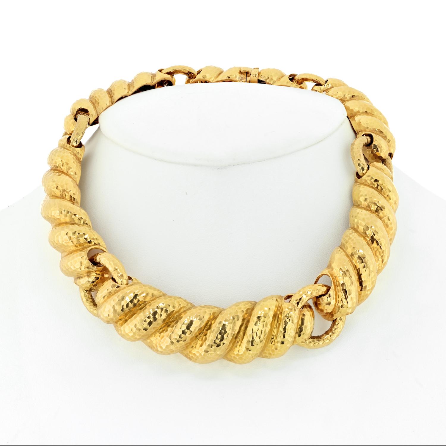 Marked by a bold geometric design, this 18K yellow gold necklace by David Webb makes a fashionable statement. Its hand-hammered texture is a signature of the New York-based designer, symbolizing the uniqueness and hand-executed artistry of David
