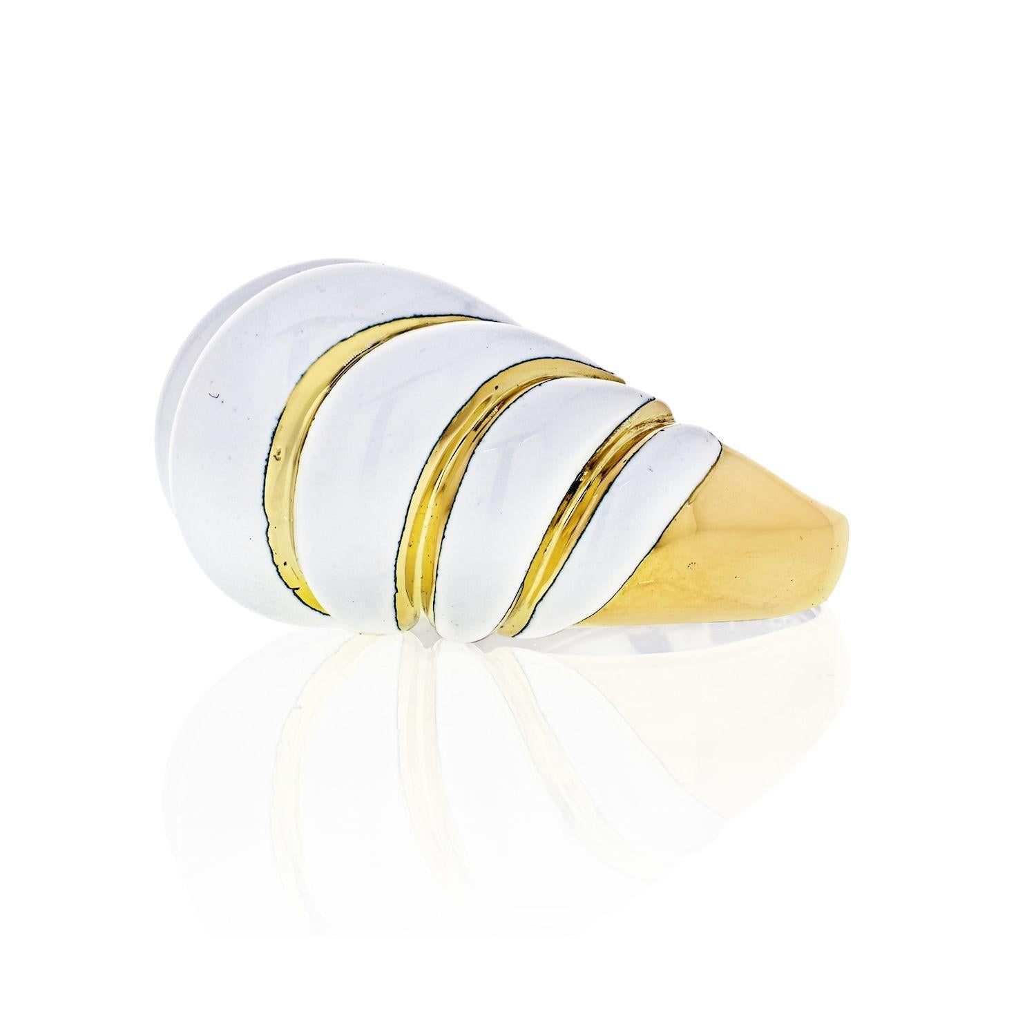 Fused to yellow gold under high temperature is the beautiful white enamel over tiered bombe rows. From acclaimed jewelry designer David Webb, a magnificent 18 karat dome ring, elegantly appointed in shimmering white enamel.
Width:18mm 
Off finger: