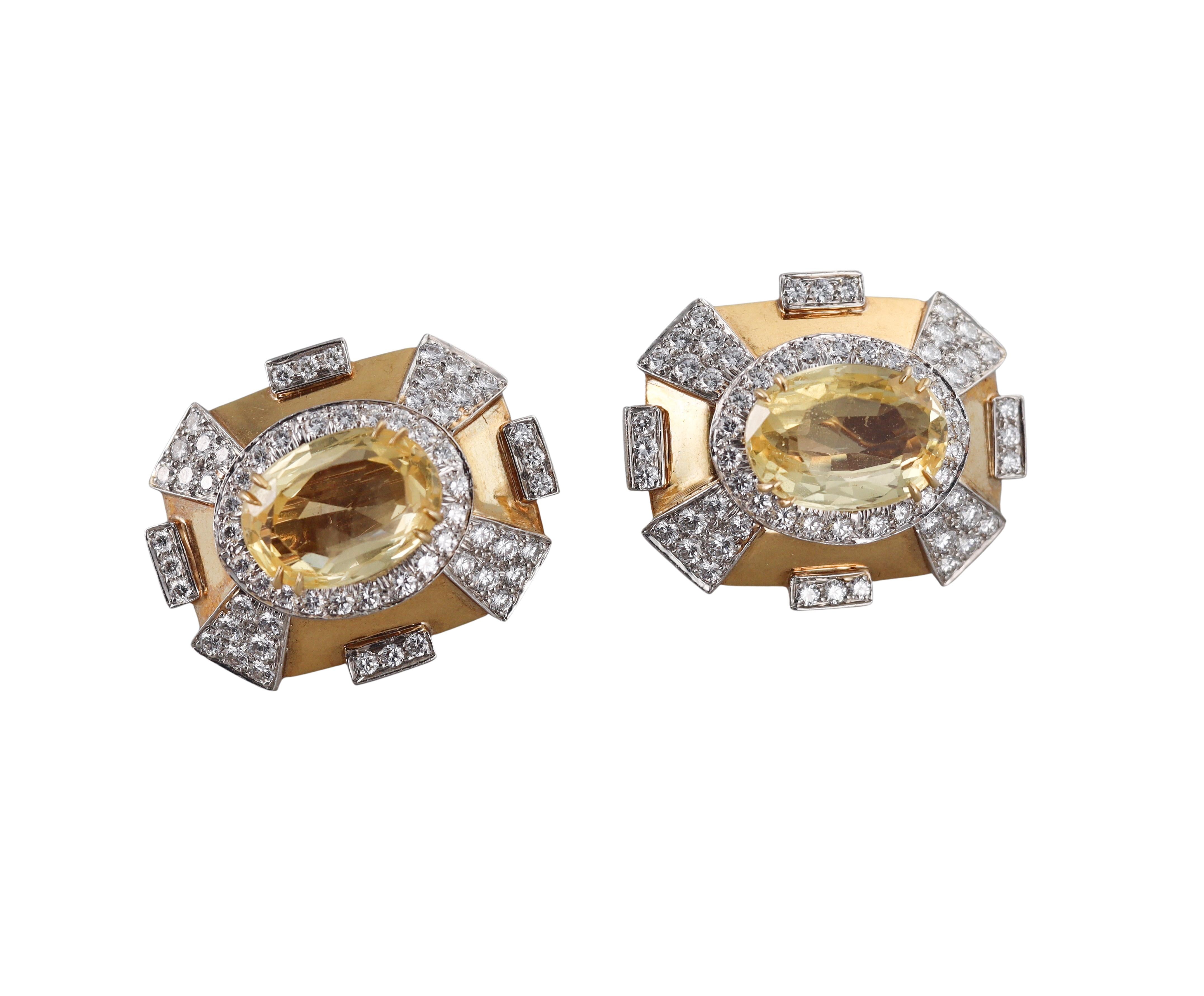 Pair of large impressive earrings by David Webb, set in 18k yellow gold and platinum. Set with center oval yellow sapphires (each stone is approx. 11.5ct , measuring 15.5 x 11.2 x 8.3mm). Surrounded with approx. 3.30ctw GH/VS diamonds. Earrings