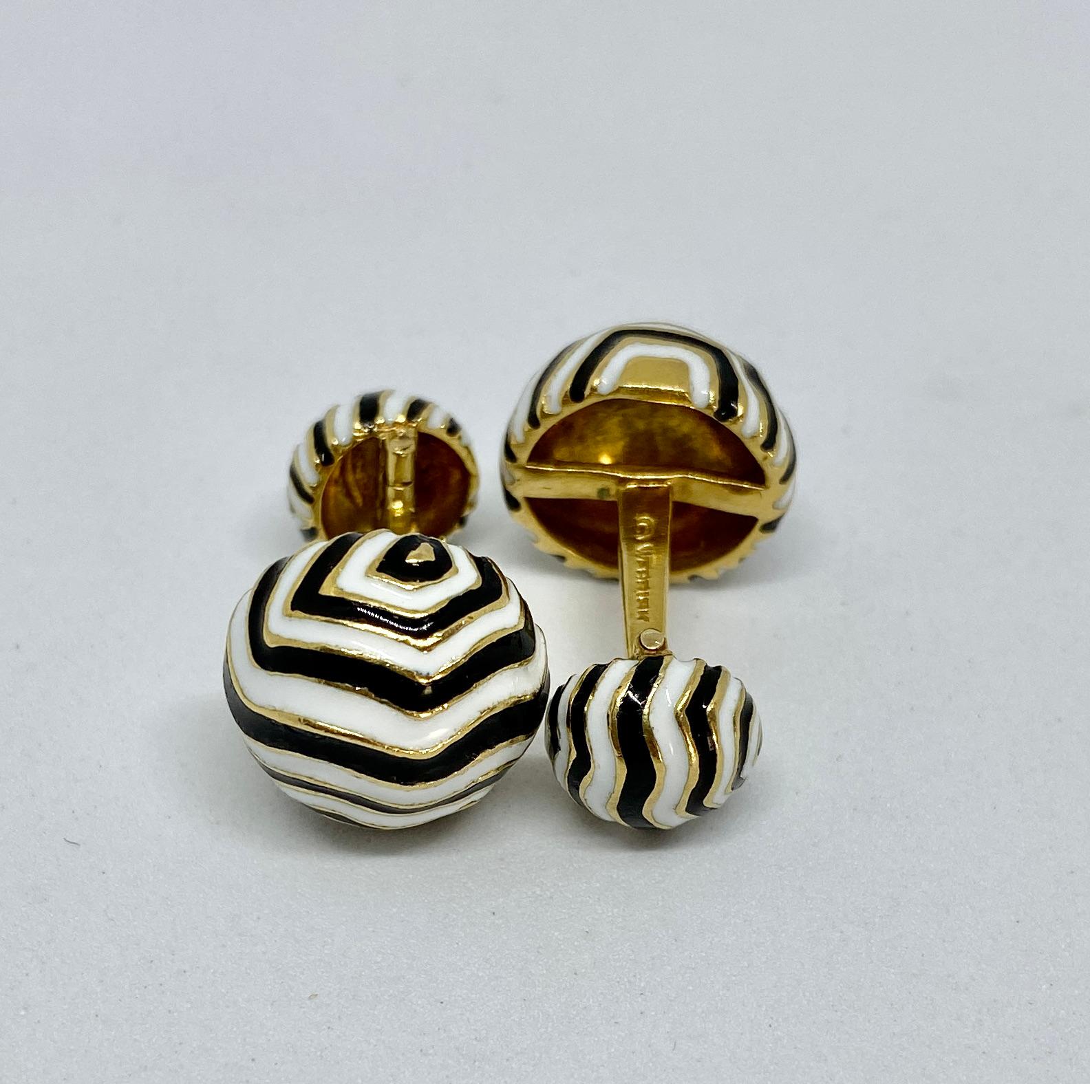 Striking, unmistakable Zebra Stripe cufflinks in 18K yellow gold with black and white enamel by David Webb.

The cufflink faces measure 15.1mm in diameter, while the hinged backs measure 10.2mm in diameter. Together the cufflinks weigh a very