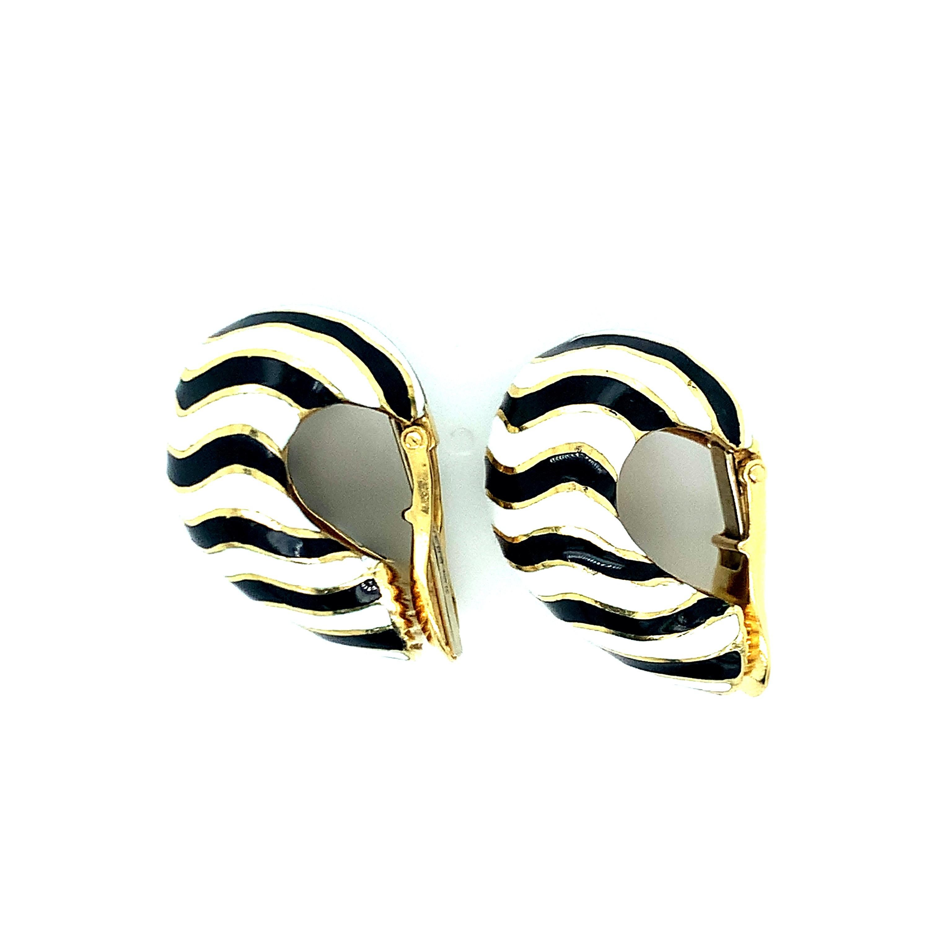 From David Webb's Zebra collection, these ear clips feature the famous African animal's black and white stripe print. Set on 18 karat yellow gold, these ear clips weigh 32.2 grams. Signed WEBB. 