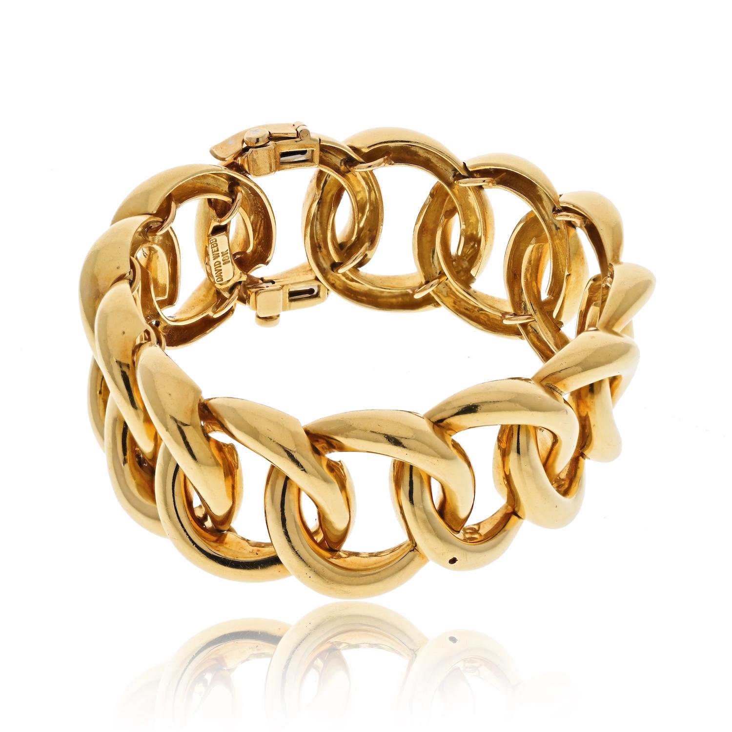 The vintage 18k yellow gold curb link bangle bracelet designed by David Webb is a true masterpiece of jewelry. With a wrist size of 6.5 inches and a width of 23mm, this bracelet is a statement piece that will capture the attention of any admirer of