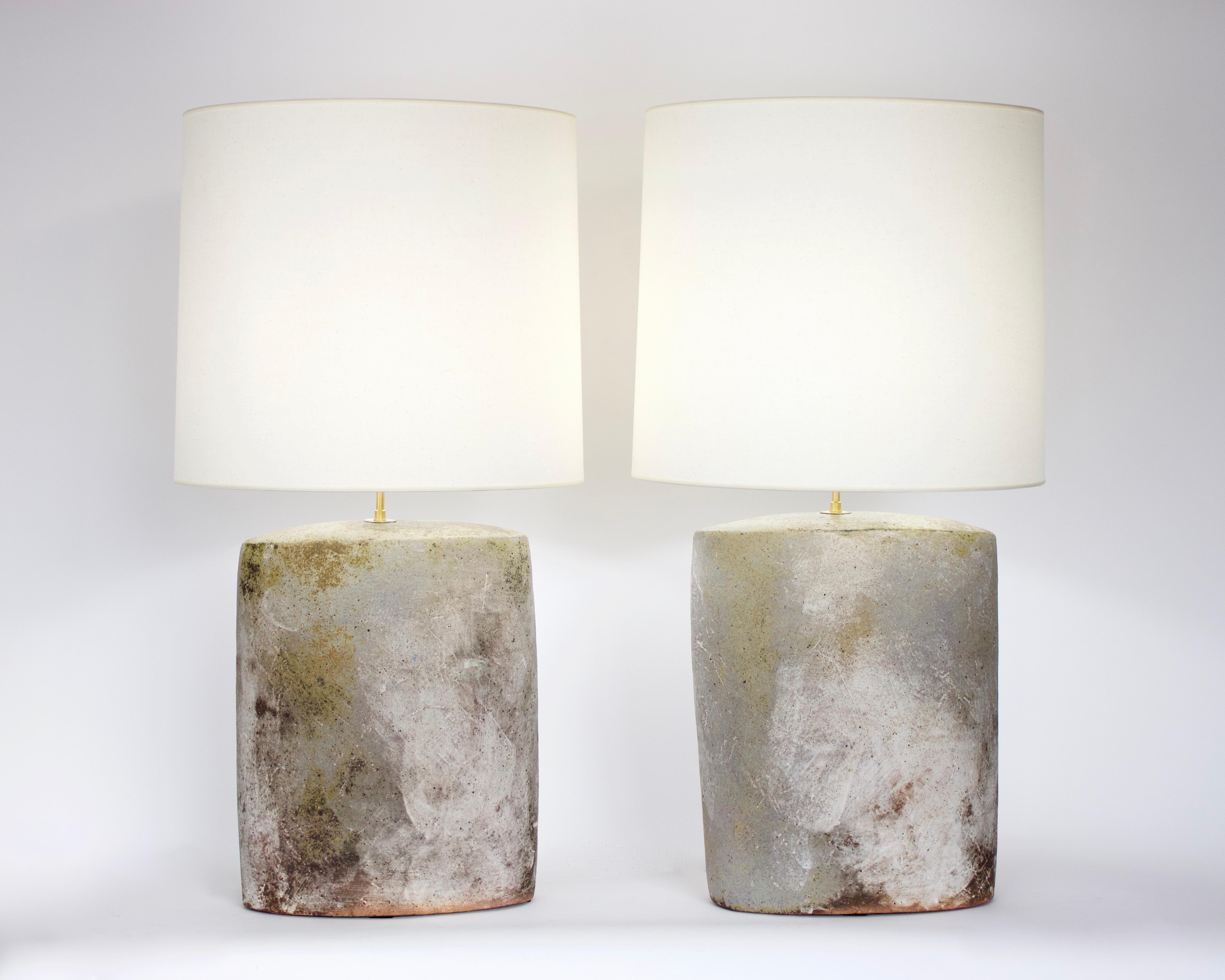 Pair of David Whitehead French ceramic artist working wood fired ceramic table lamps. 
Whitehead works in the famous pottery village of La Borne where he fires all of his work in wood kilns. Beautiful smoke pattern and individual subtle gray, beige,
