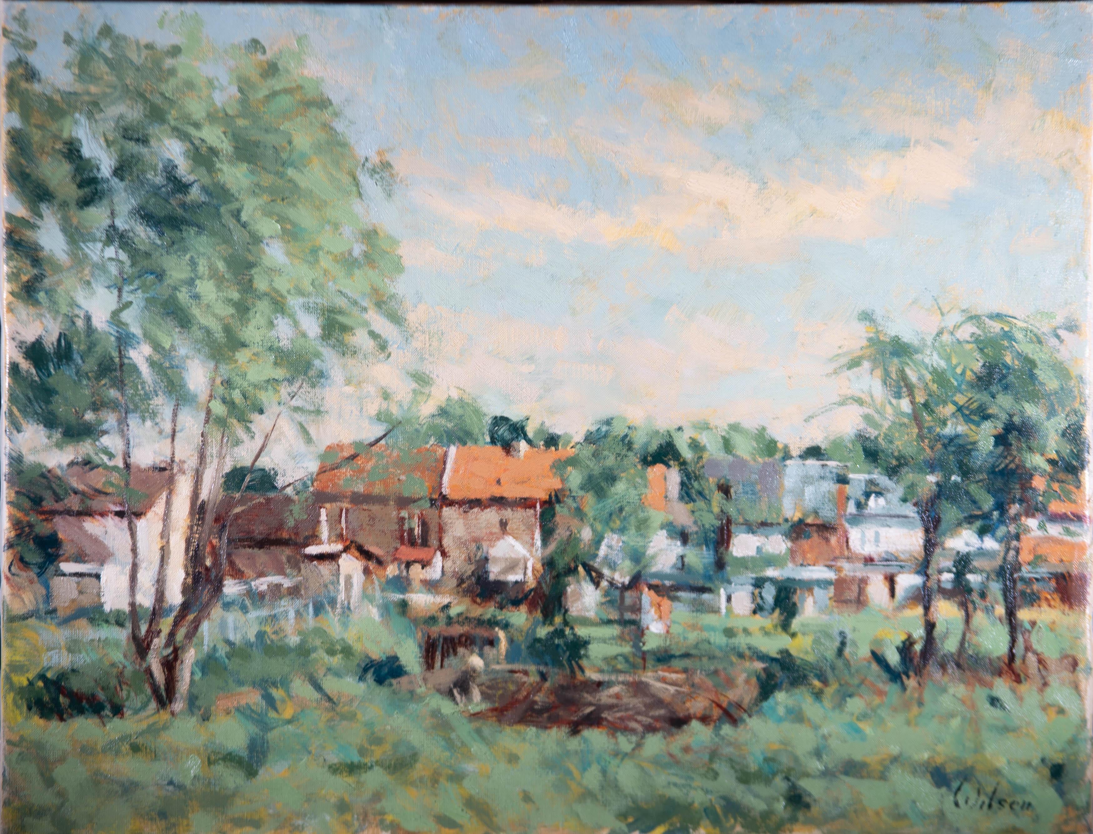 A fine oil showing a sunny view of houses at the edge of a meadow, surrounded by trees. The artist has captured the chaotic greenery at the height of British Summer Time. The artist has signed to the lower right corner and the painting is on canvas
