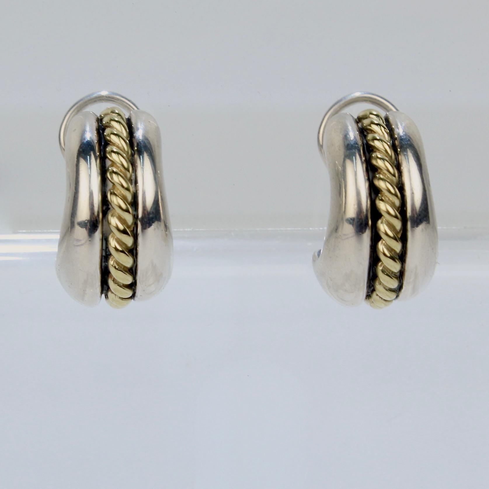 A fine pair of signed, designer David Wysor earrings.

In sterling silver with a 14k gold twisted wire set at the center of each.

With omega clip backs. 

Marked with the David Wysor mark, 925 for sterling silver fineness, and 585 for 14k gold