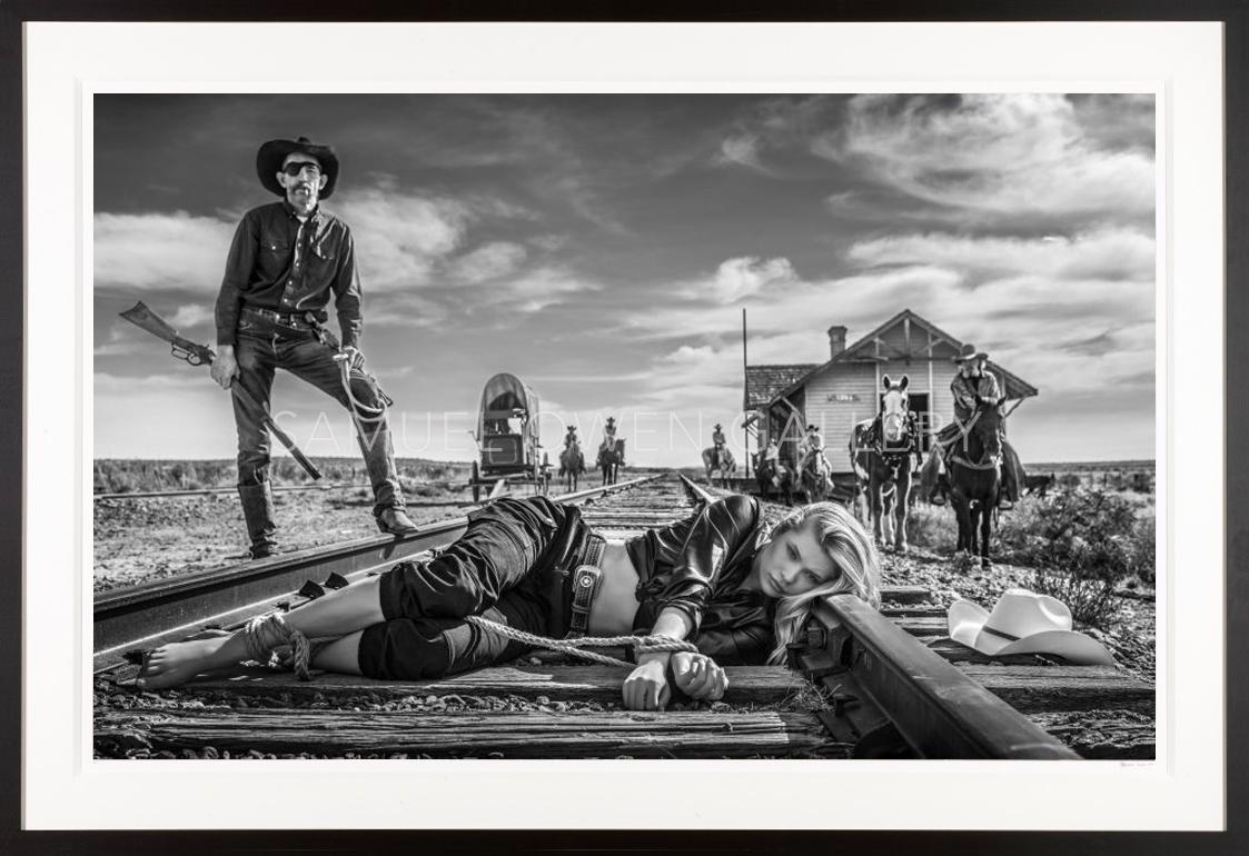 David Yarrow Black and White Photograph - 3:10 to Yuma / Josie Canseco Western theme Tied to Train Tracks with Cowboy
