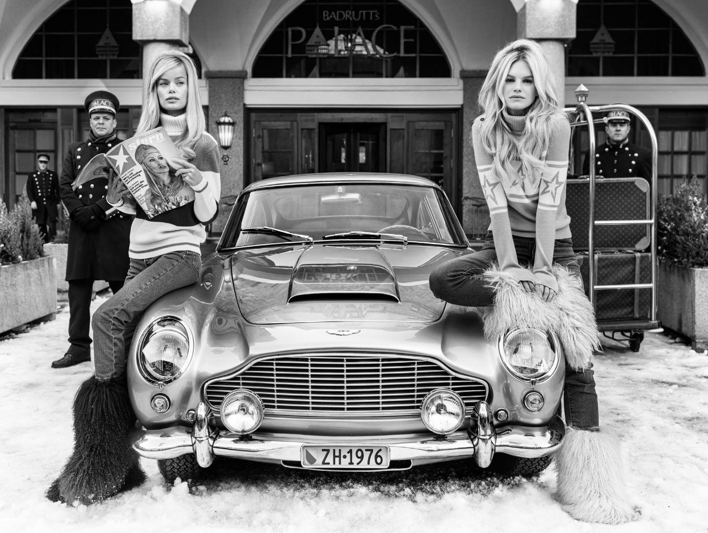 David Yarrow Black and White Photograph - Badrutt's - b&w photograph of two models posing next to a car in St. Moritz 