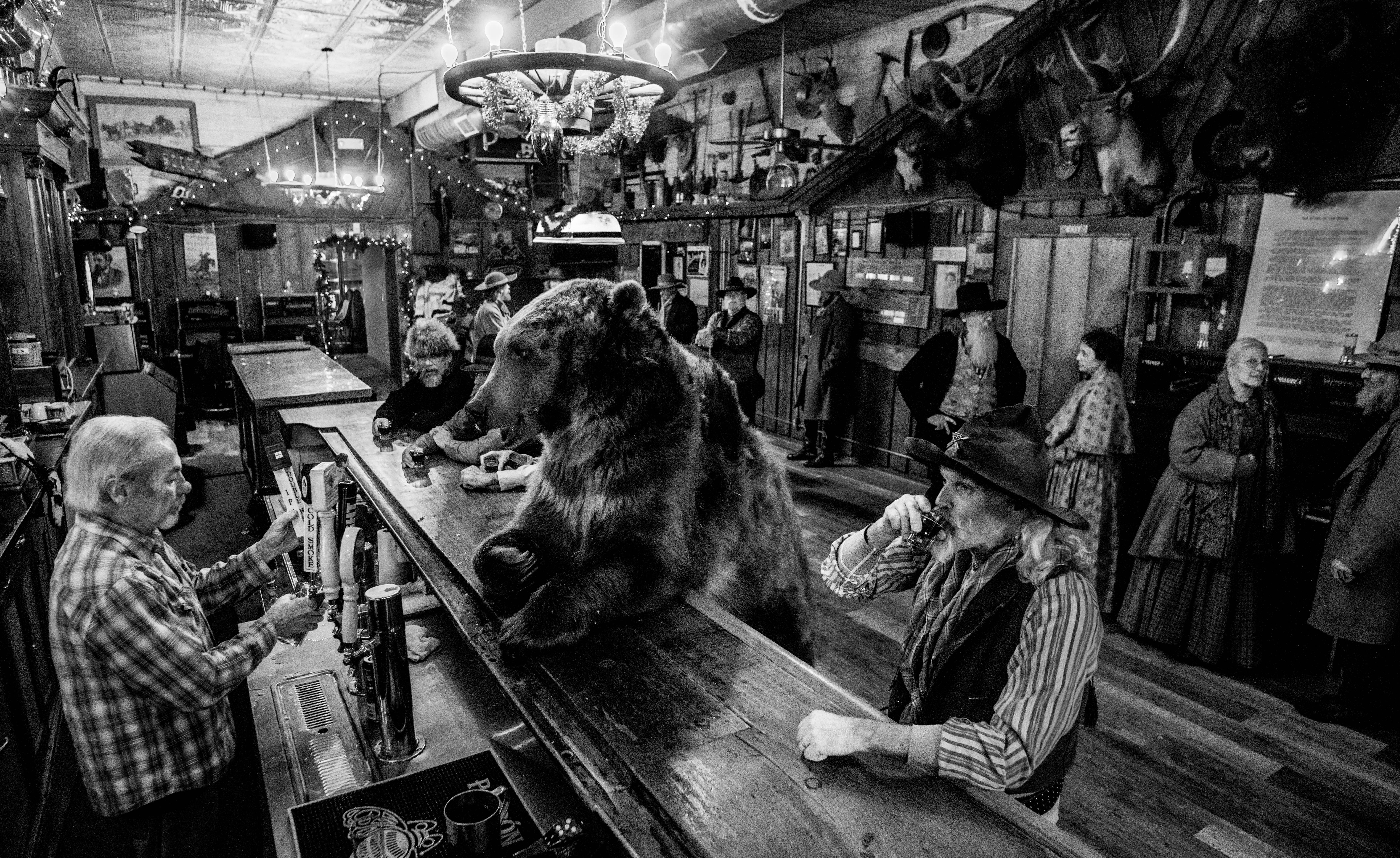 David Yarrow Black and White Photograph - Bear Walks into a Bar