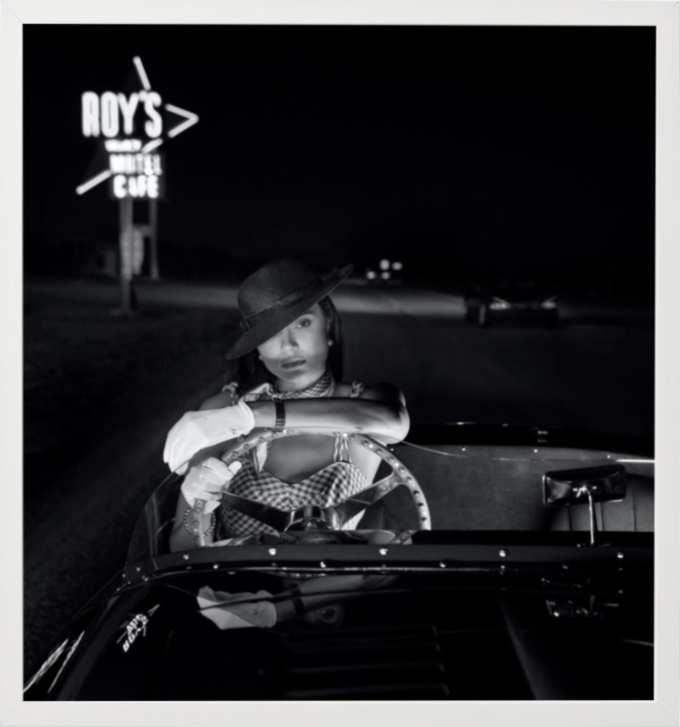 California Dreaming - b&w photograph of model Daniela Braga in car on route66 - Photograph by David Yarrow