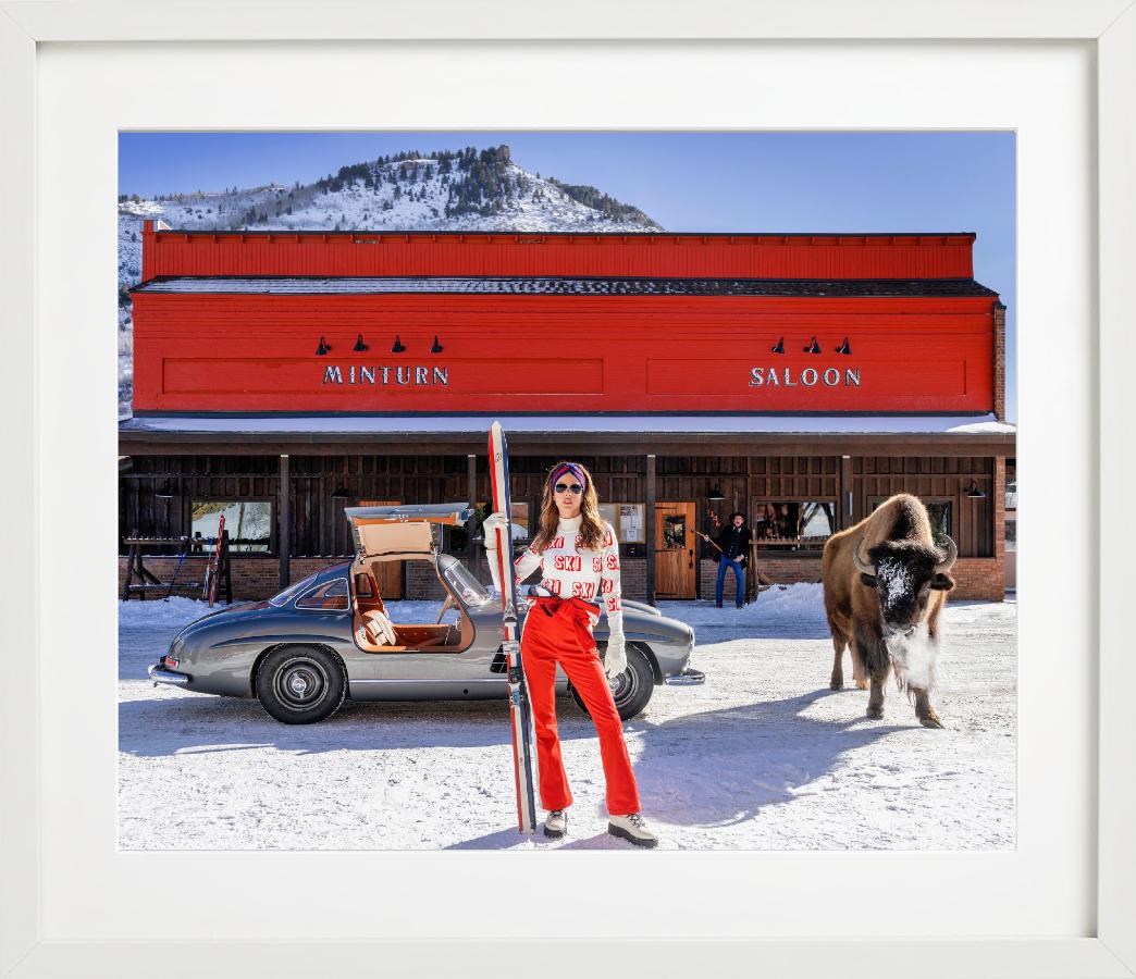 Code Red - Model and Buffalo in front of red Saloon, fine art photography, 2024 - Photograph by David Yarrow