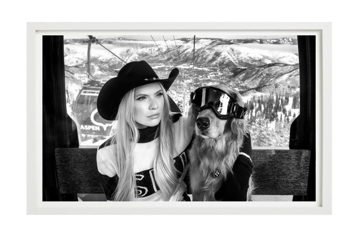 Gondola - model Josie Canseco with a dog wearing glasses in a ski gondola - Photograph by David Yarrow