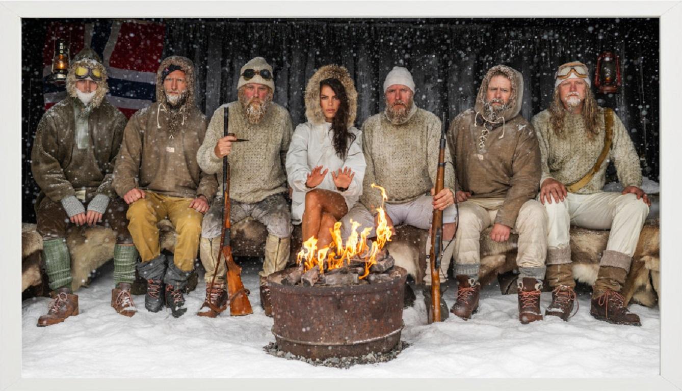 Ice Ice Baby - Brooks Nader with Polar Explorers Sitting Around Fireplace Colour - Black Figurative Photograph by David Yarrow