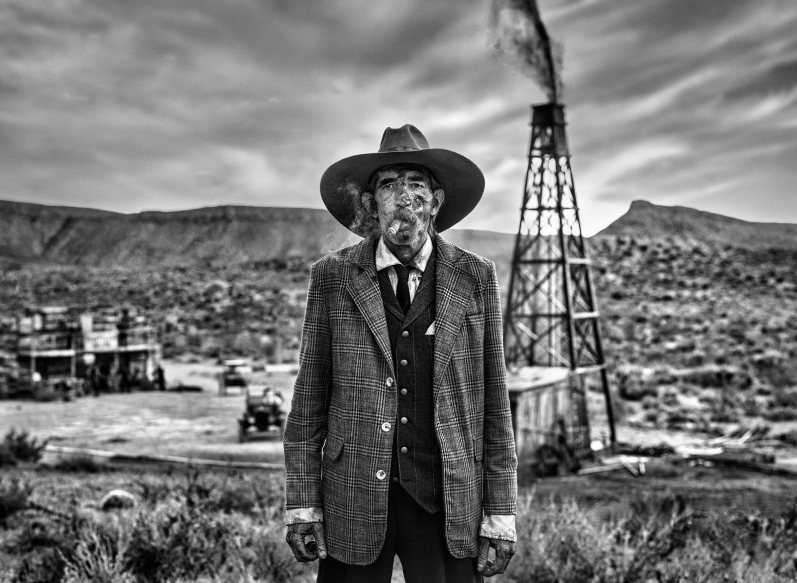 David Yarrow Black and White Photograph - 'I'm an Oil Man' - Old Man in front of Oil derrick, fine art photography, 2023