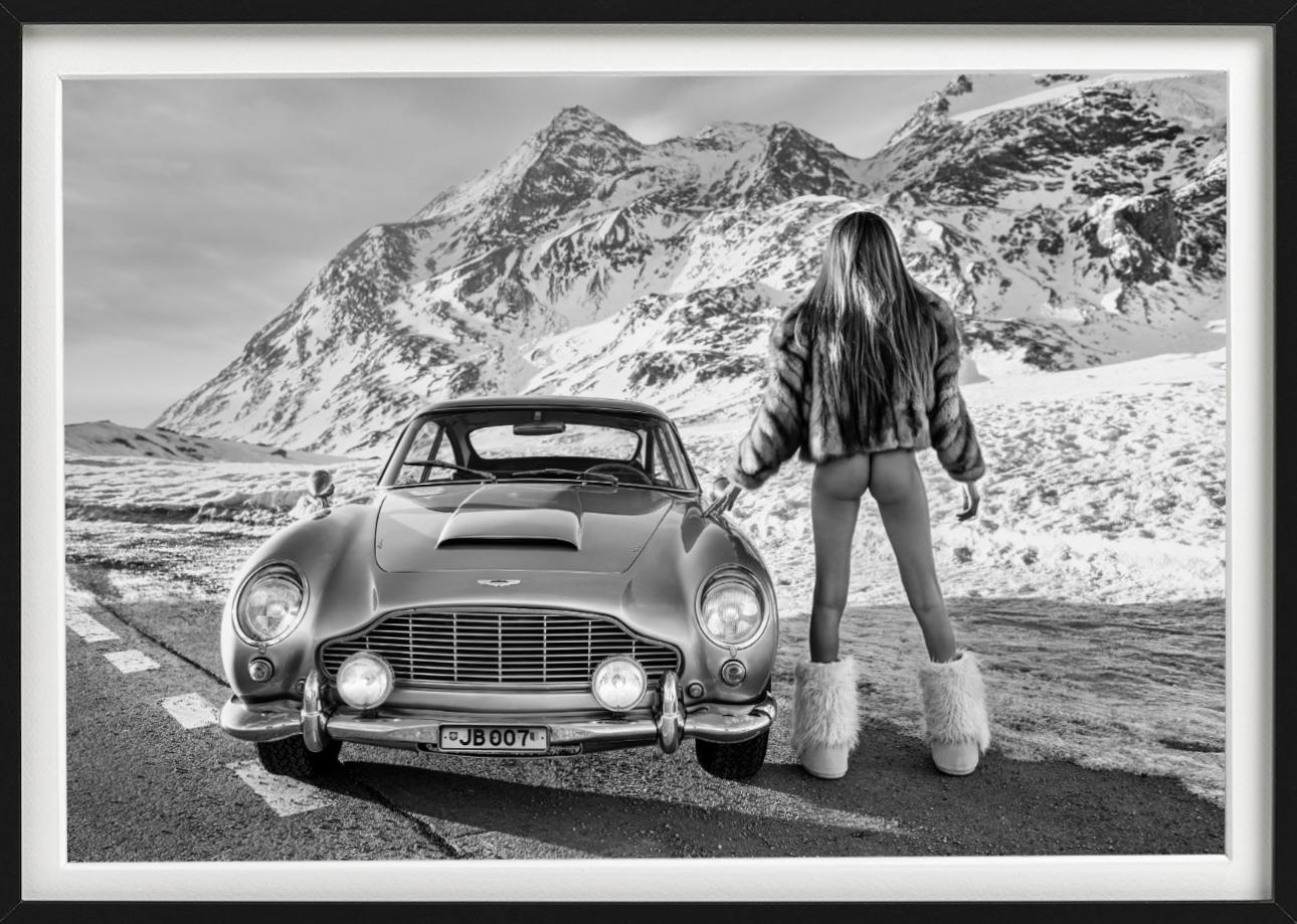 James? - b&w photograph showing a nude model from behind with a James Bond car - Photograph by David Yarrow