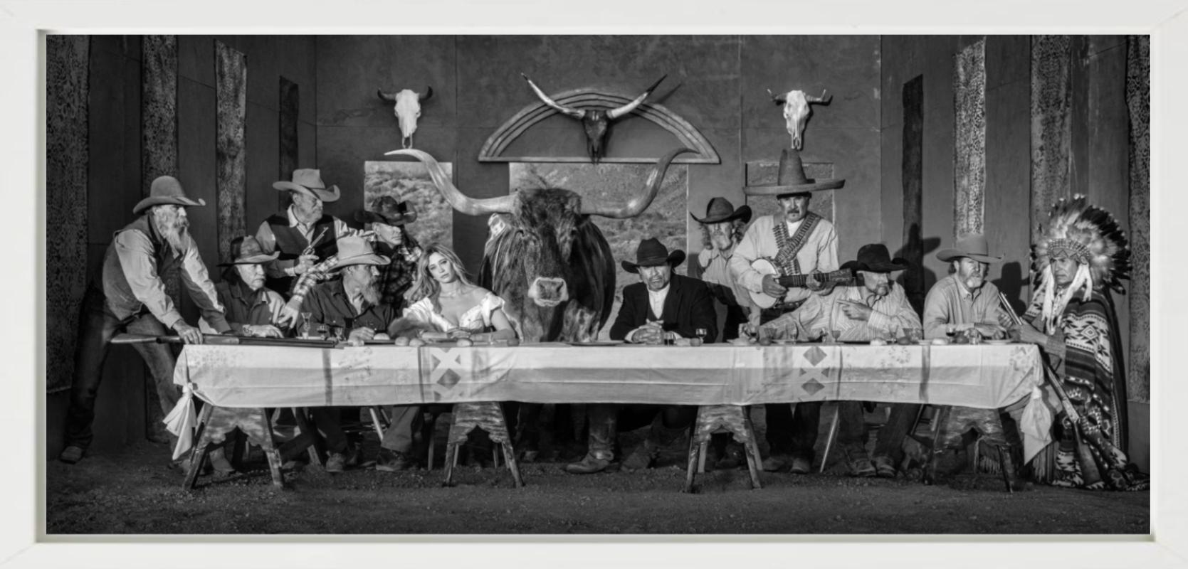 Last supper in texas - model and cowboys dining in western look - Photograph by David Yarrow