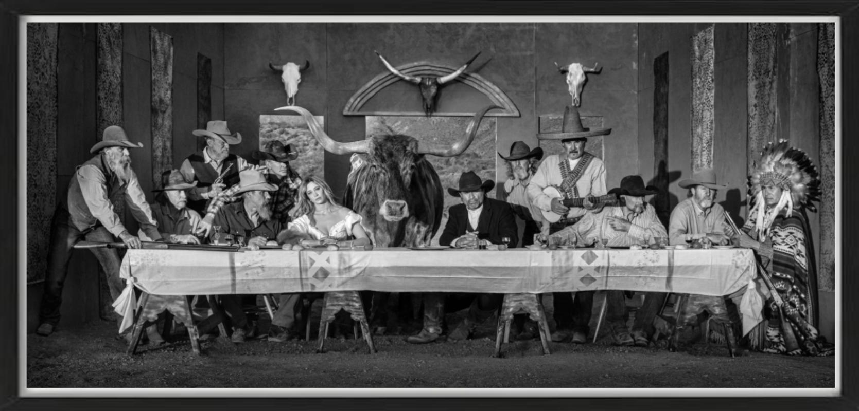 David Yarrow Black and White Photograph - Last supper in texas - model and cowboys dining in western look