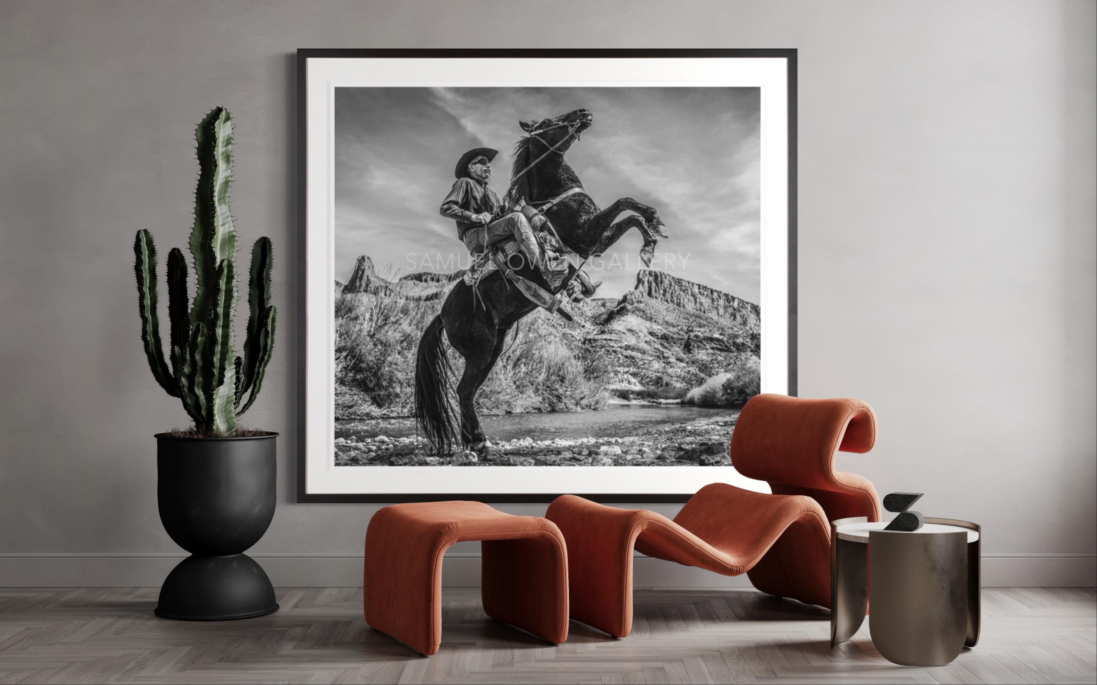 Vivere senza pensionanti Foto in bianco e nero di un cowboy a cavallo scattata in Messico - Black and White Photograph Grigio di David Yarrow