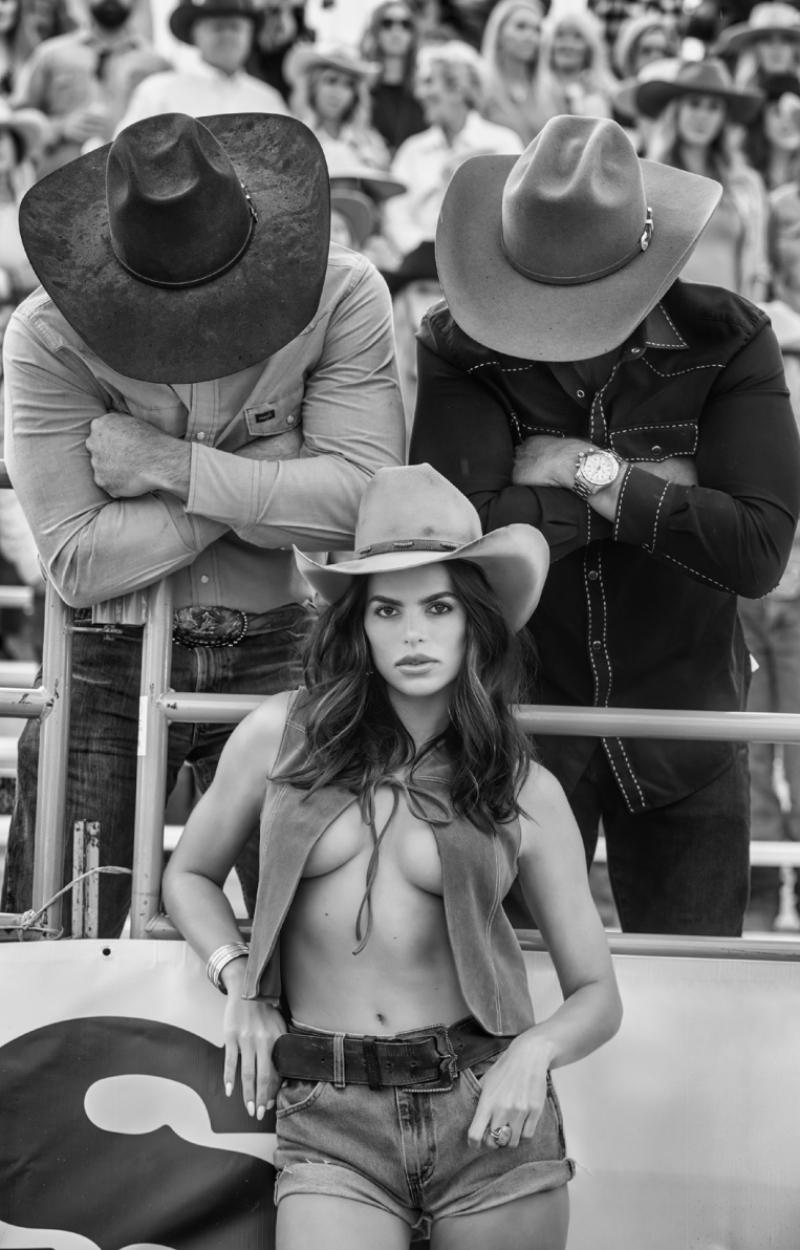 David Yarrow Black and White Photograph - 'Nice Hats' - Model and Two Cowboys at the Rodeo, fine art photography, 2023