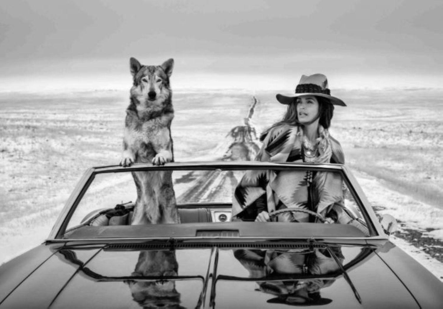 David Yarrow Black and White Photograph - On the road again - the supermodel Cindy Crawford in a car with a wolf