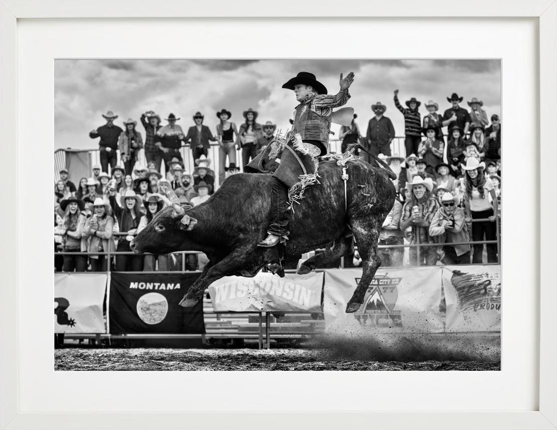 'Ride the Bull' - Rodeo Rider on the Bull, fine art photography, 2023 - Photograph by David Yarrow