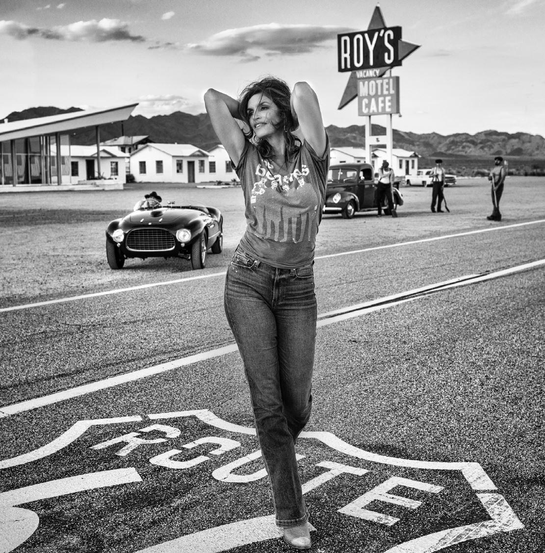 David Yarrow Figurative Photograph - Roy's - Supermodel Cindy Crawford walking in front of 1950s motel on route 66