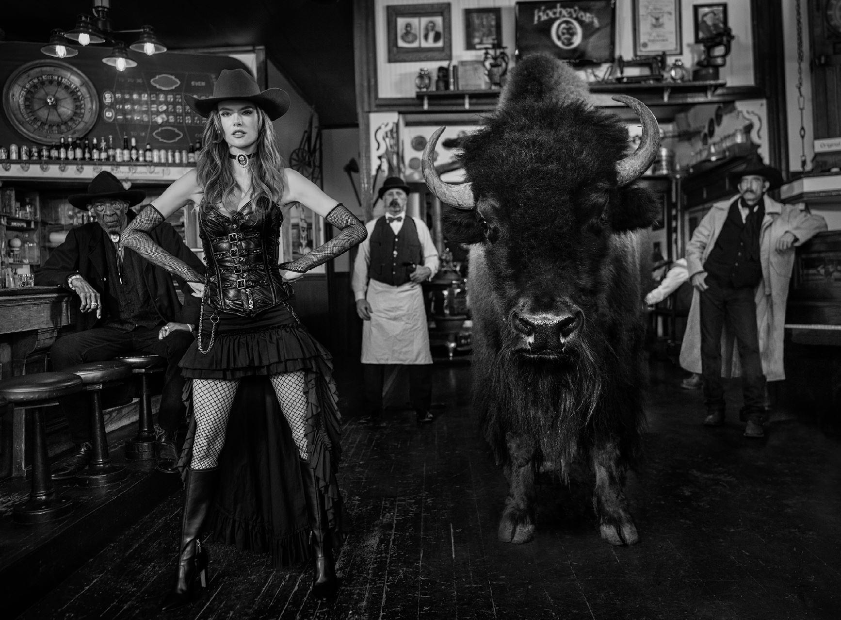 David Yarrow Black and White Photograph - Russian Roulette - Model and Bison in a Western Bar, fine art photography, 2024