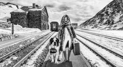 Switzerland - Model and dog standing in front of a train station in the winter