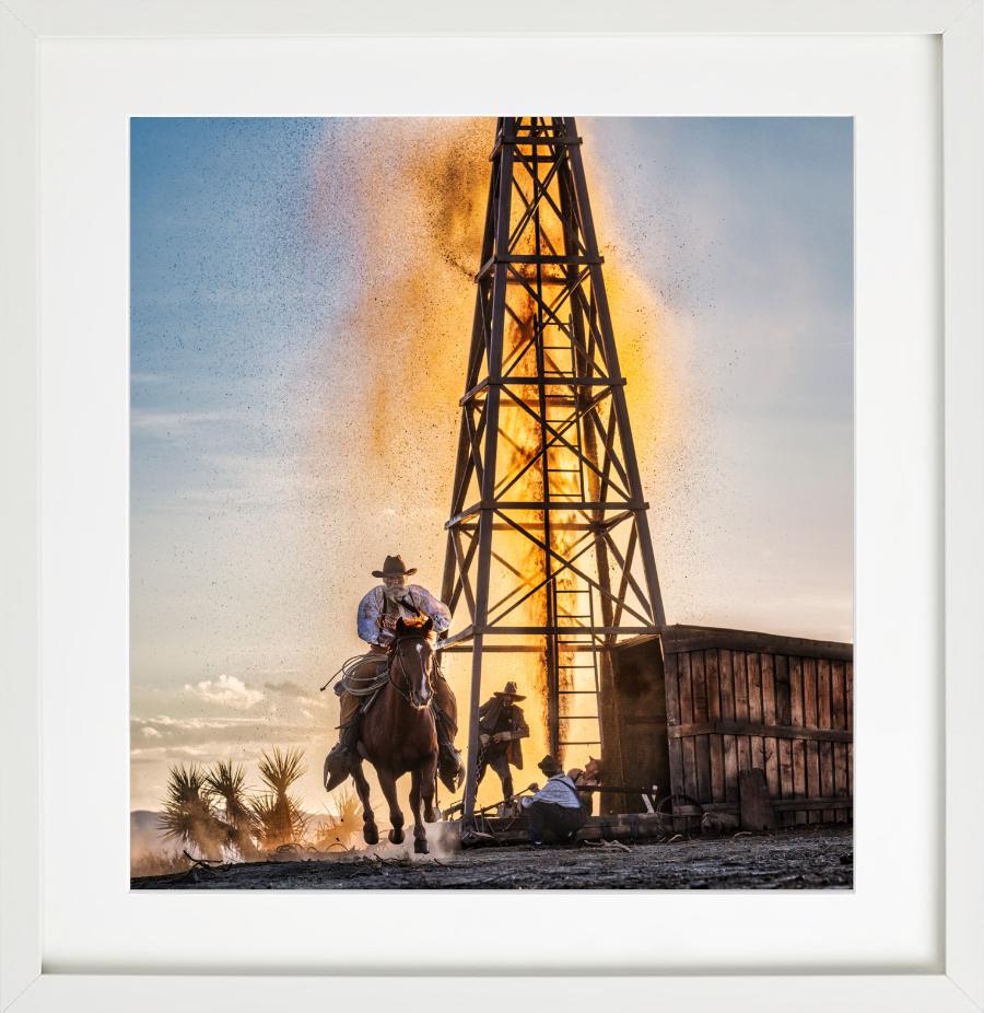 The golden age of Oil - cowboy in front of oil derrick, fine art photography - Photograph by David Yarrow