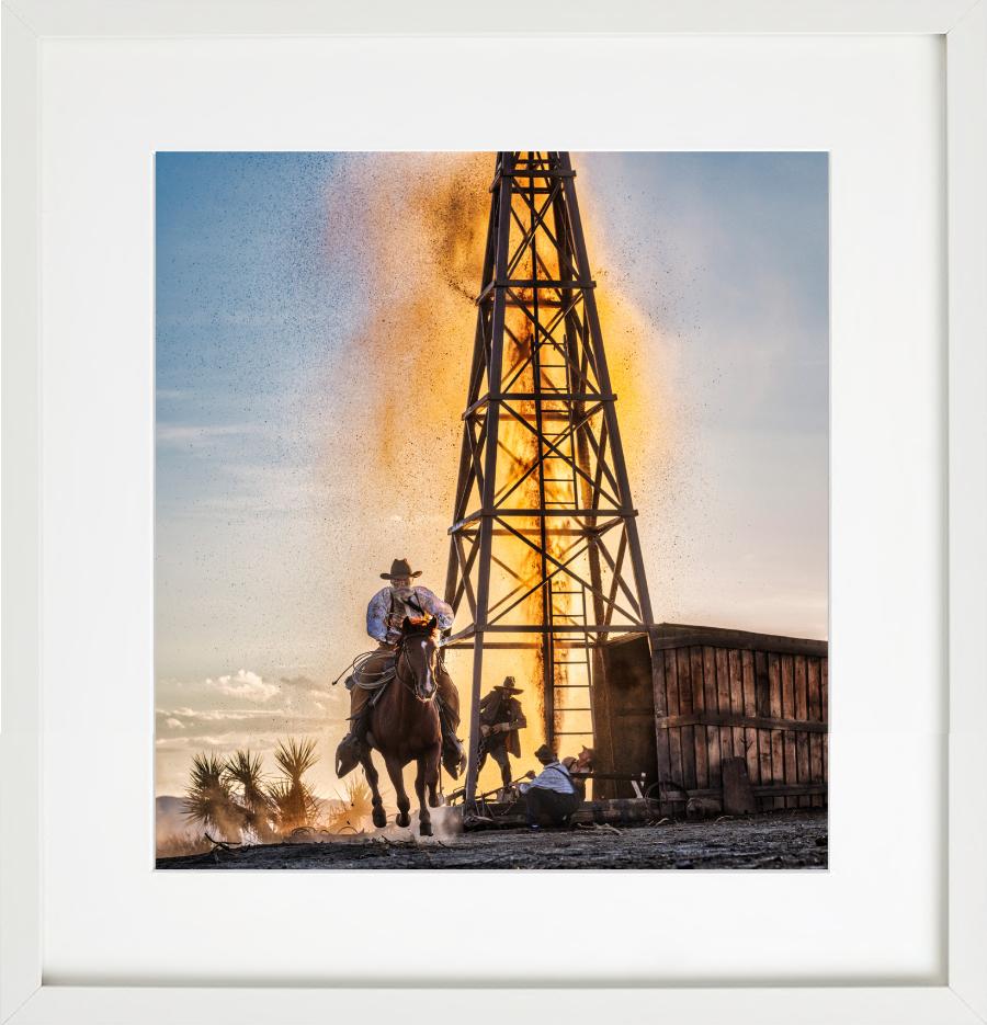 The golden age of Oil - cowboy in front of oil derrick, fine art photography - Beige Figurative Photograph by David Yarrow