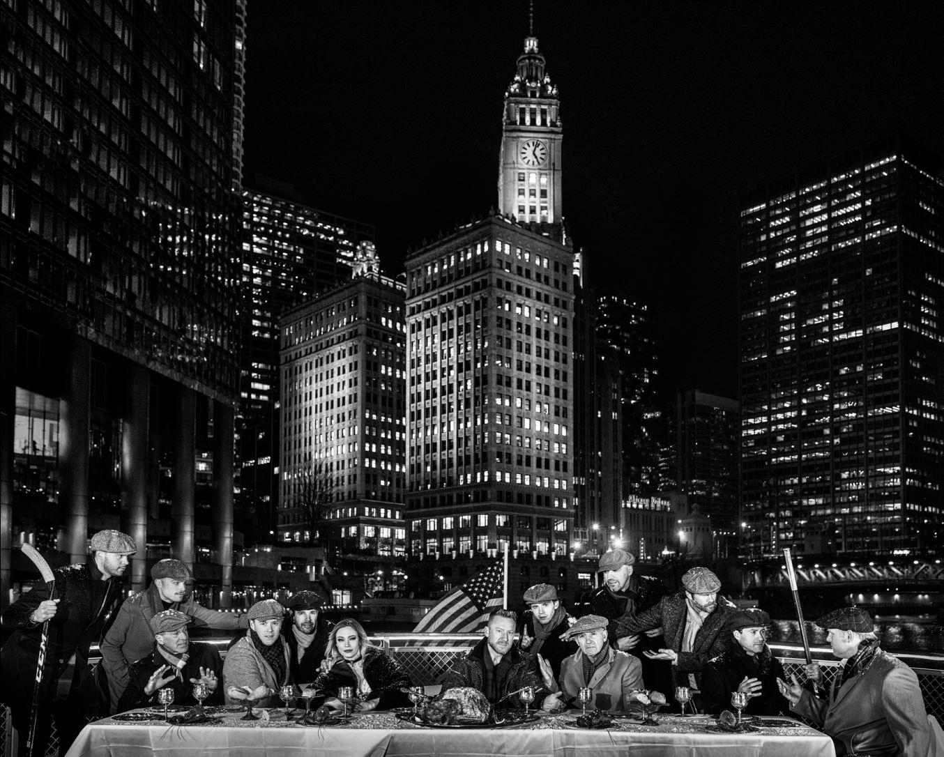 David Yarrow Black and White Photograph - The Last Supper in Chicago - Chicago skyline and Blackhawks players sitting down