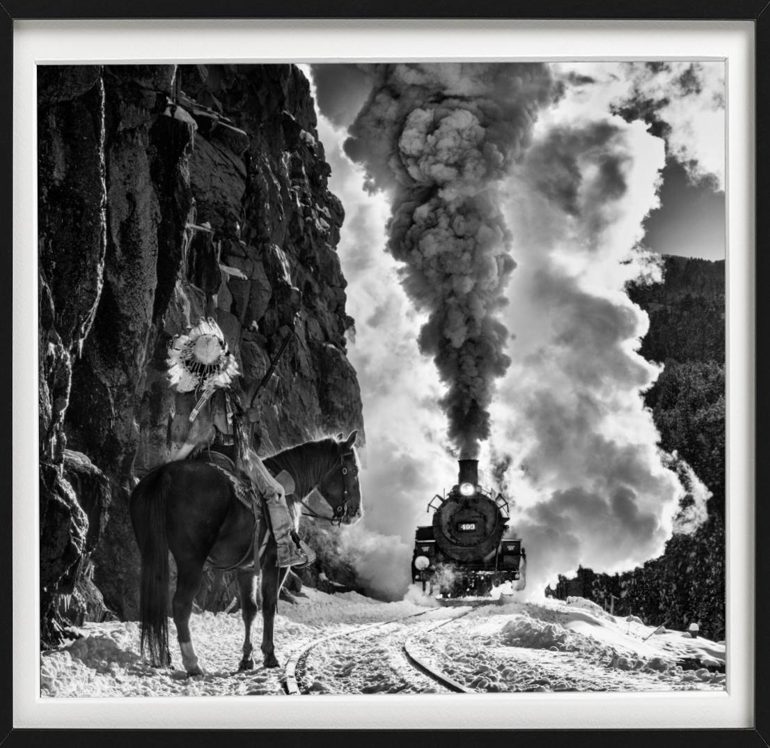 The Manifest Destiny - b&w photograph showing a train and a native american  - Photograph by David Yarrow