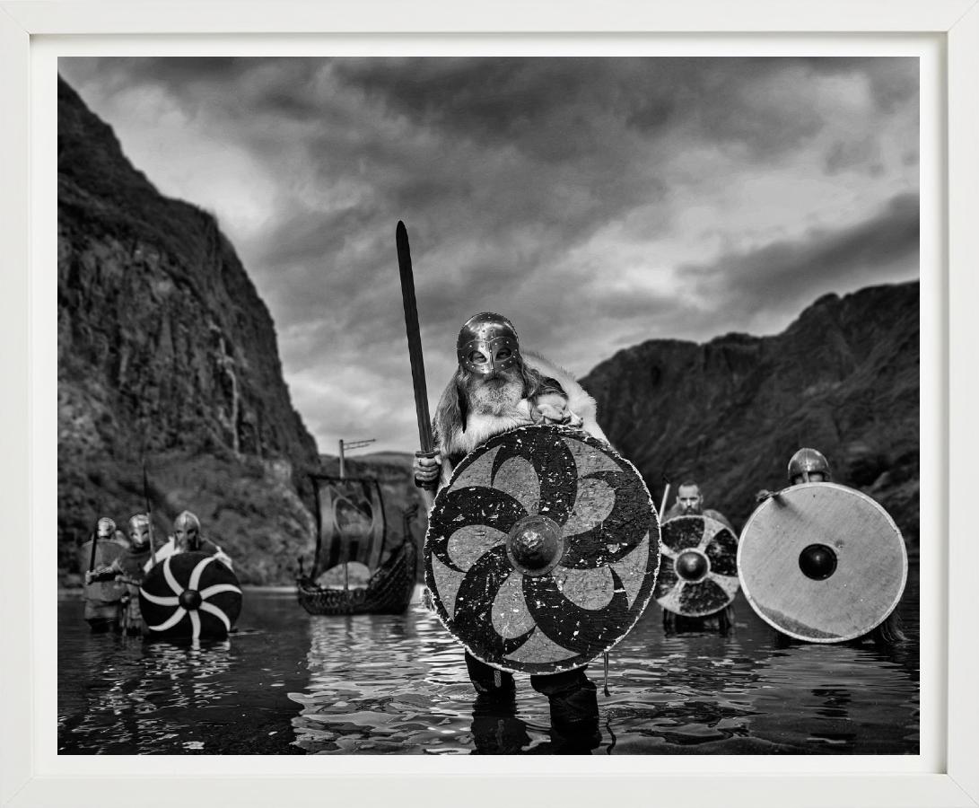 'Vikings' - Vikings standing in a Fjord, fine art photography, 2023 - Photograph by David Yarrow