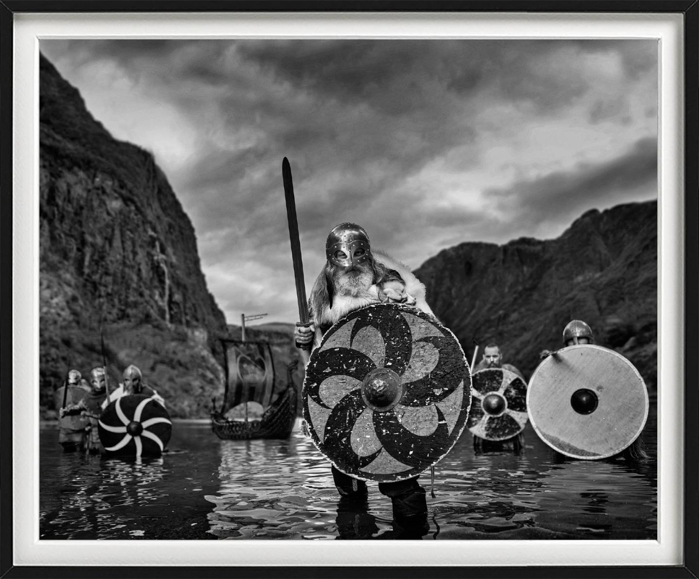 'Vikings' - Vikings standing in a Fjord, fine art photography, 2023 - Contemporary Photograph by David Yarrow