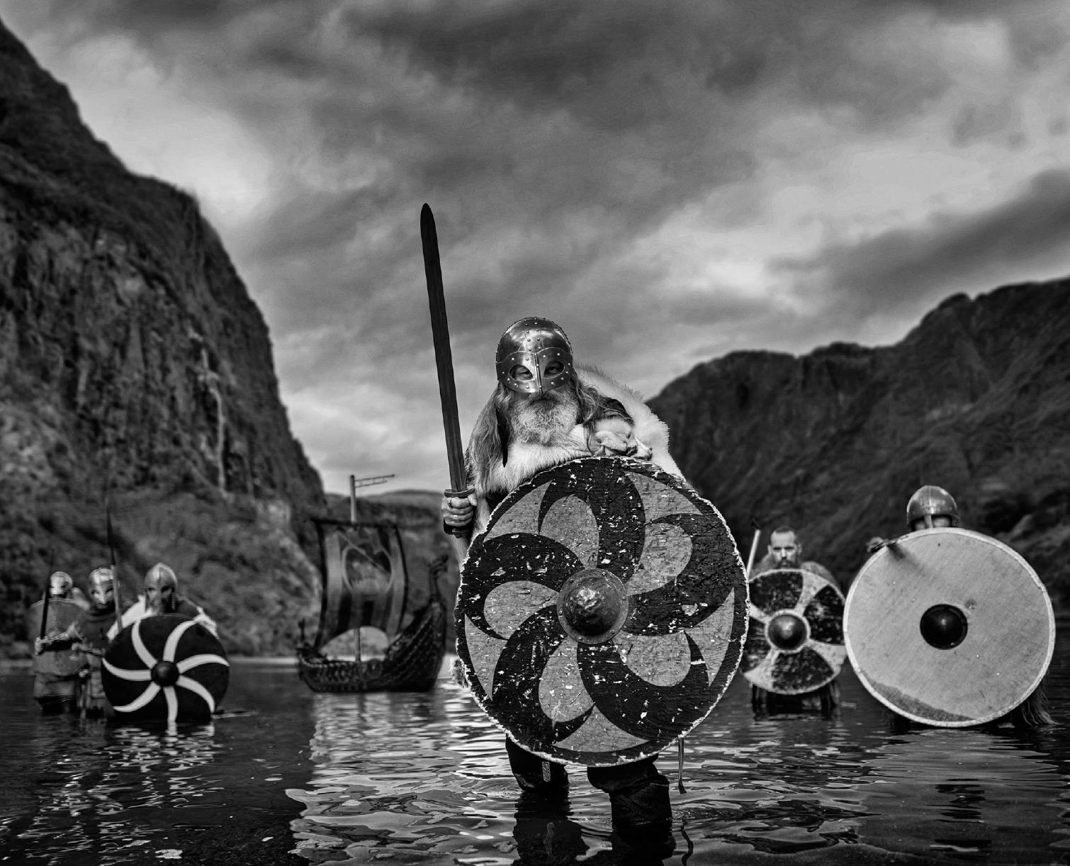 David Yarrow Figurative Photograph - 'Vikings' - Vikings standing in a Fjord, fine art photography, 2023