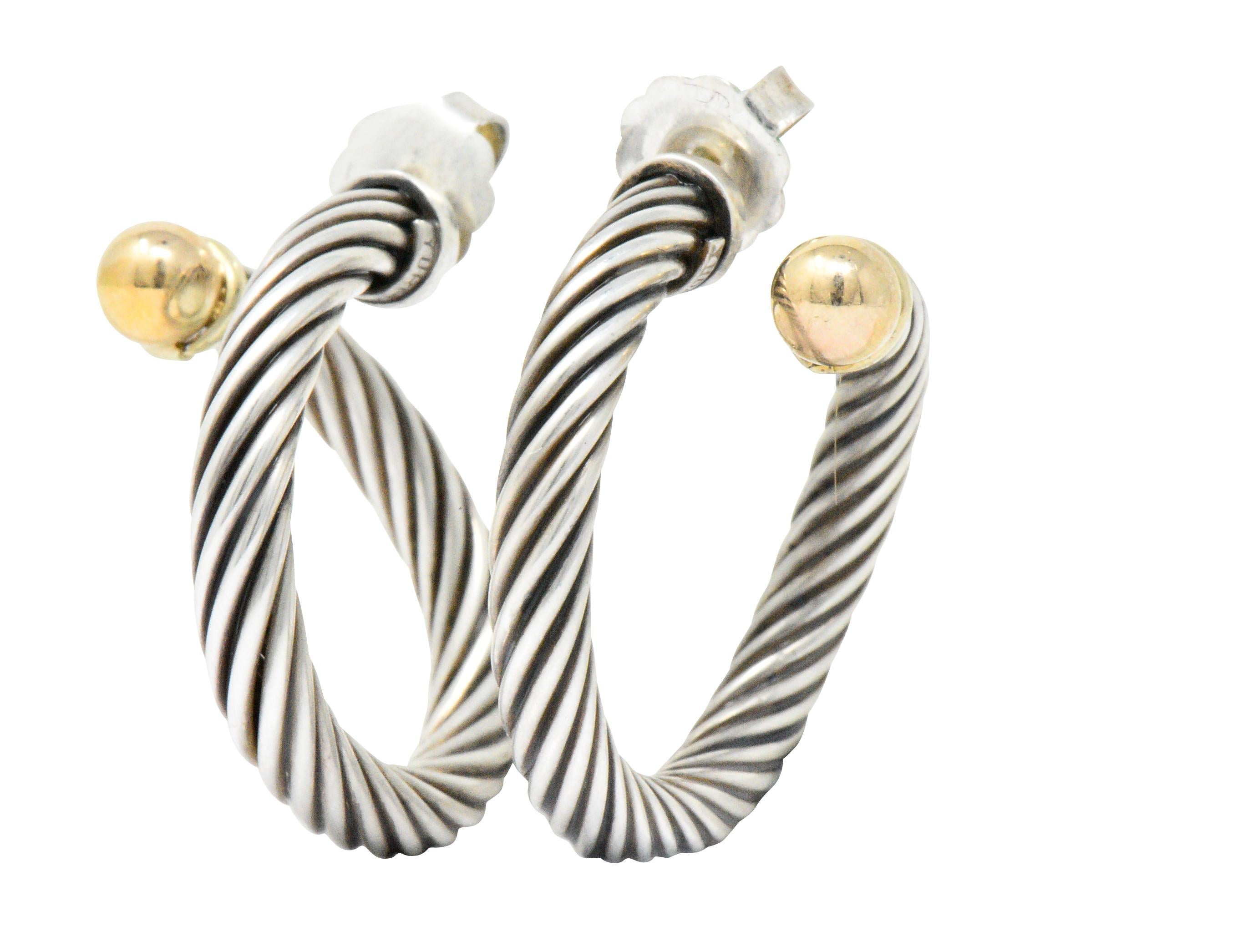 Featuring oversized sterling silver cable twist hoops with a curve

14kt gold accent balls that extend beyond the earlobe

Pierced post with oversized sterling backs

Signed Yurman Ster 14k

Measuring 31 mm with 5 mm diameter cable twist

Total