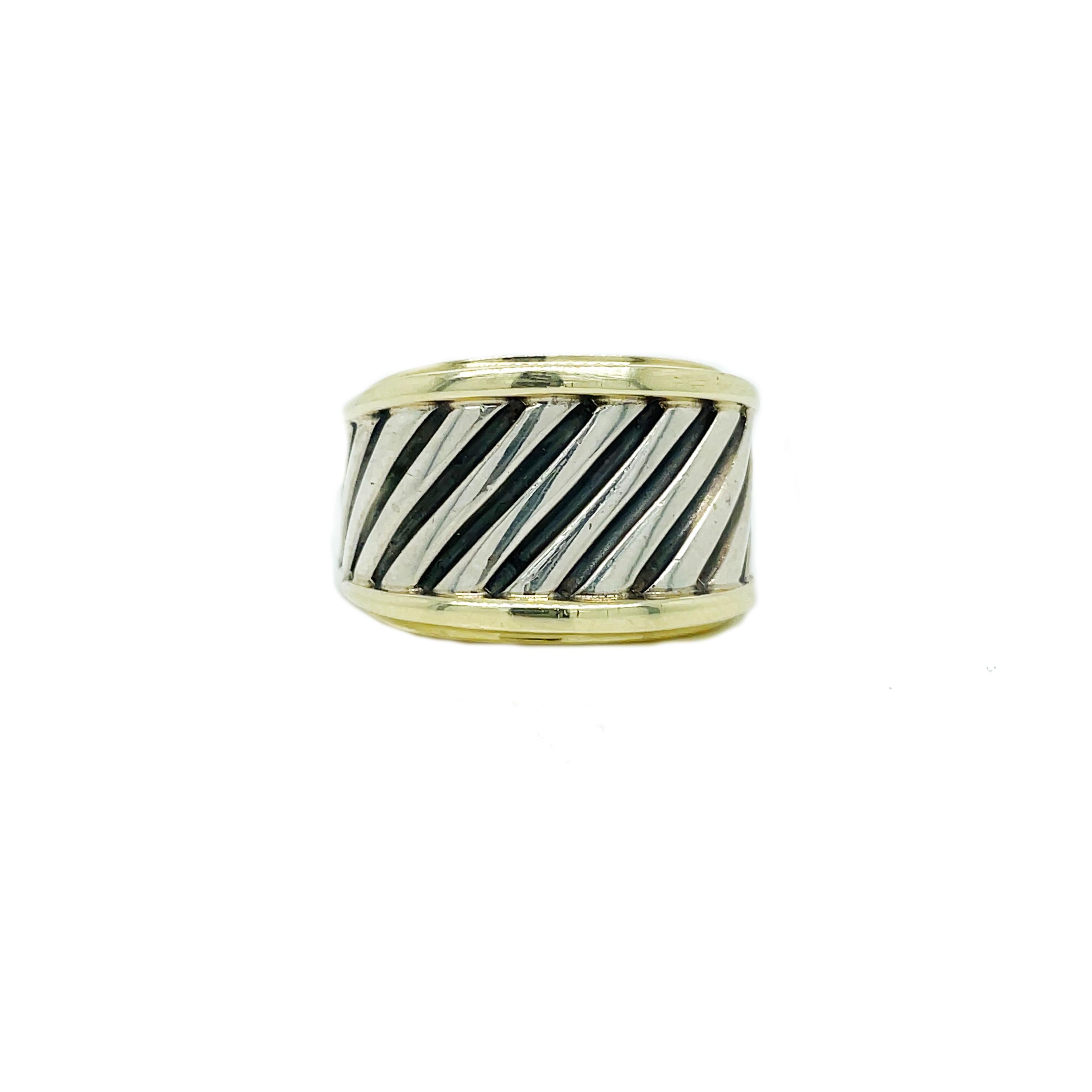 This is a classic David Yurman ring set in 14K yellow gold and bright sterling silver with a wide band and twisted cable design!  It is crafted of sterling silver and 14K yellow gold and has a simple but elegant design. The top is a rectangular