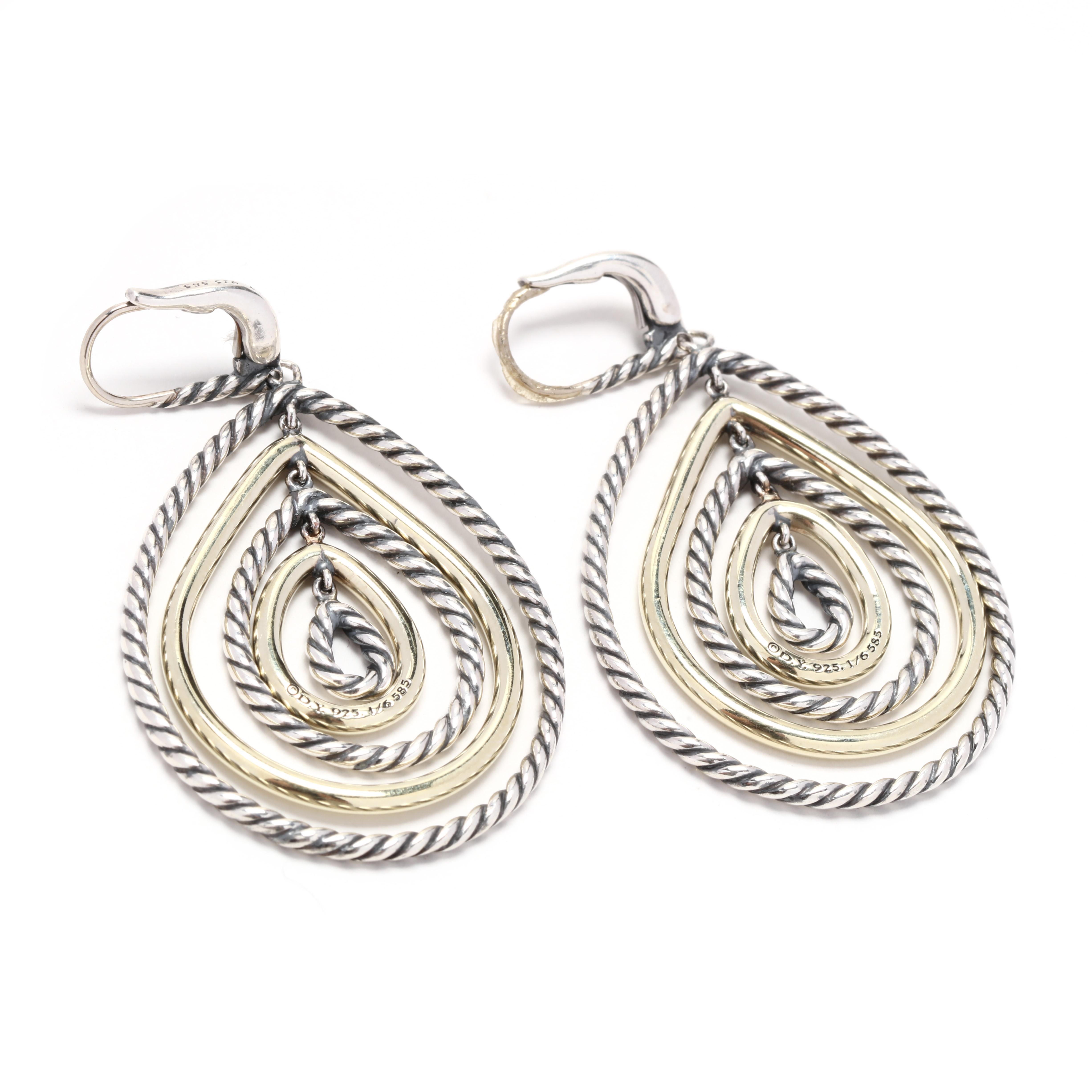 A pair of David Yurman 14 karat yellow gold and sterling silver pear shape dangle earrings. These earrings feature alternating silver cable motif and polished gold pear shape dangles with leverback closures.



Length: 2 1/8 in.



Width: 1 1/8