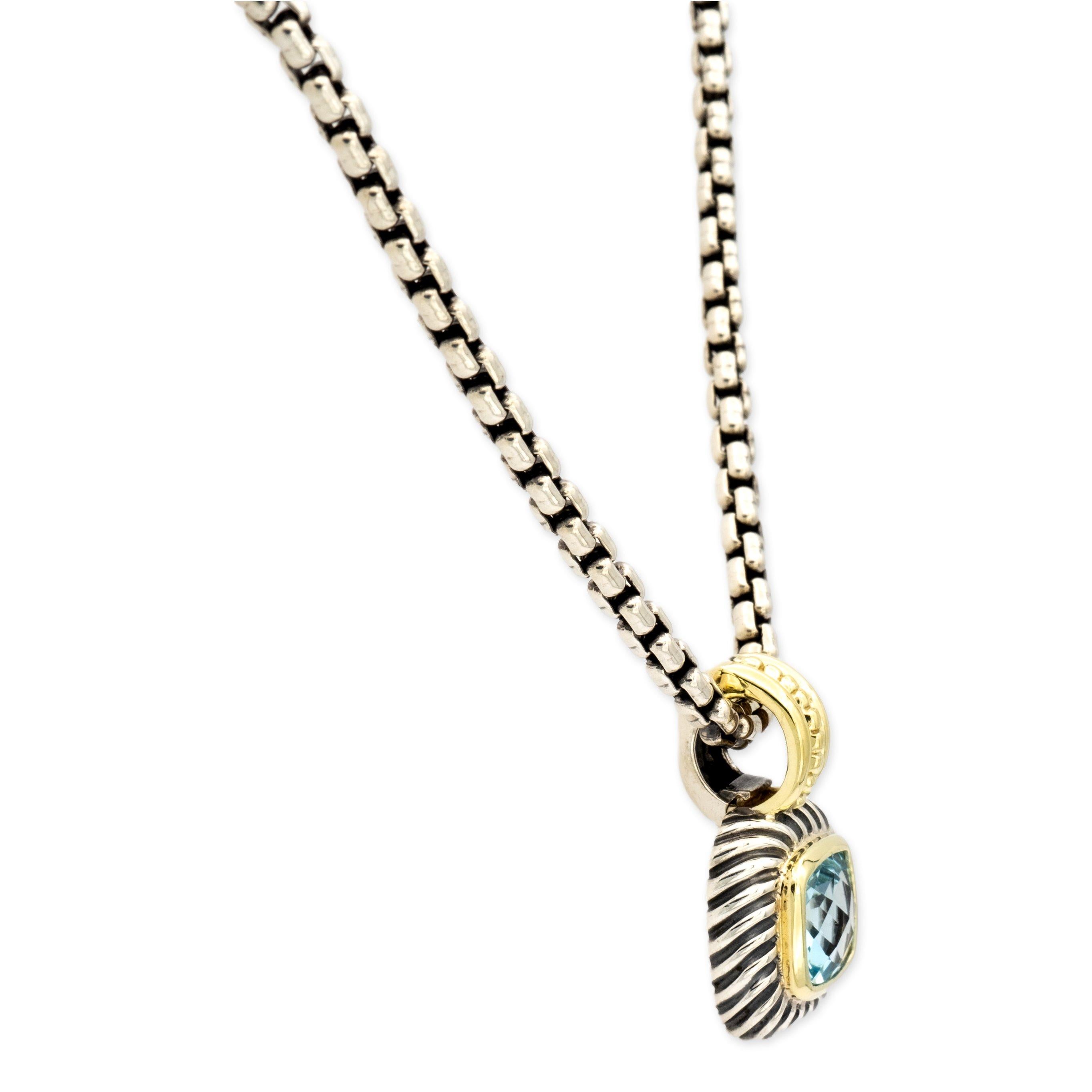David Yurman pendant necklace from the Albion collection finely crafted in sterling silver featuring a deep blue cushion shape blue topaz in the center set in a 14 karat yellow gold bezel adorned with a twisted cable outer rim. Removable hinged