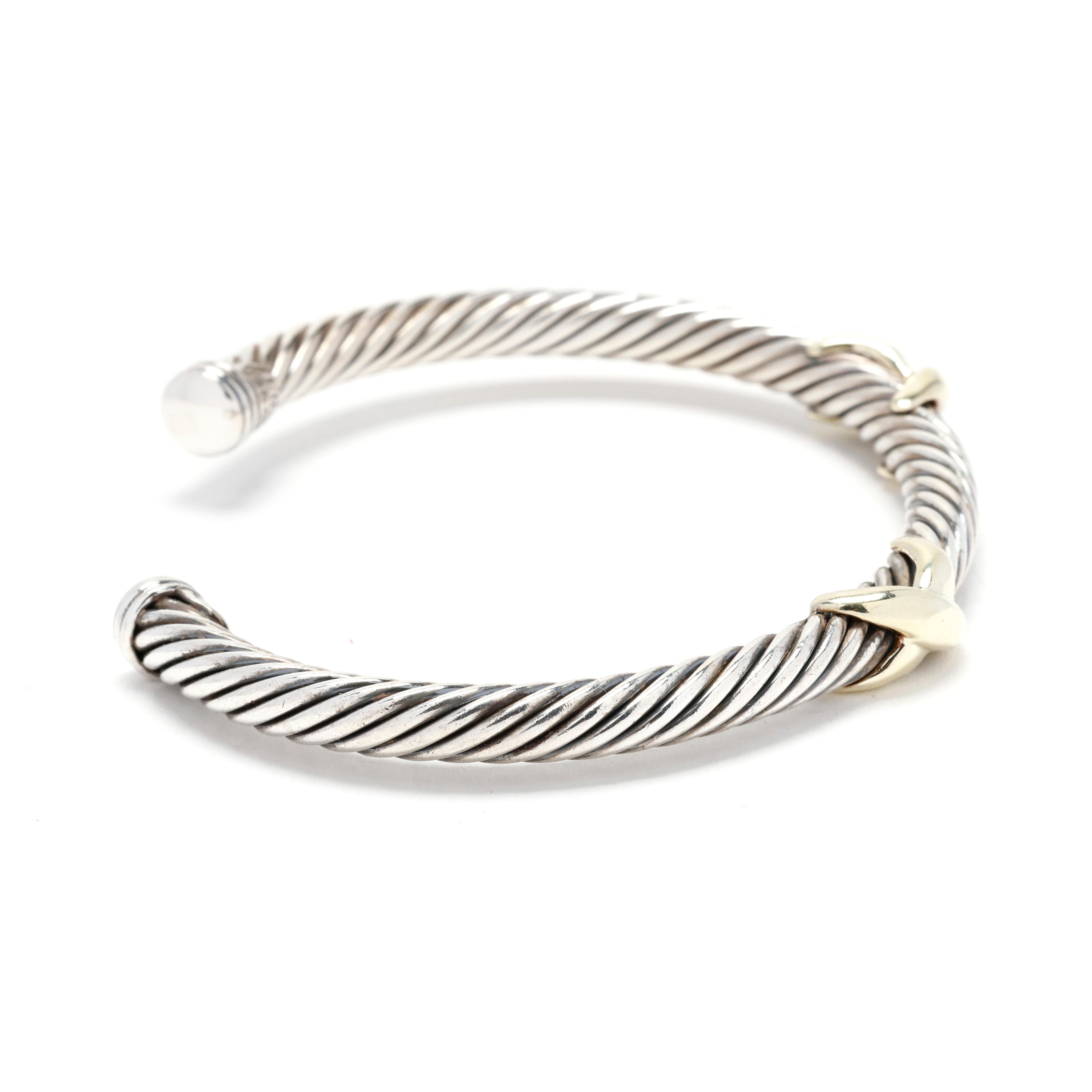 A David Yurman sterling silver 14 karat yellow gold and sterling silver double X cable cuff bracelet. This cuff bracelet features a silver cable motif cuff with a gold double X accent.



Length: 6.25 in.; adjustable



DY Size Medium



Width: 6.9