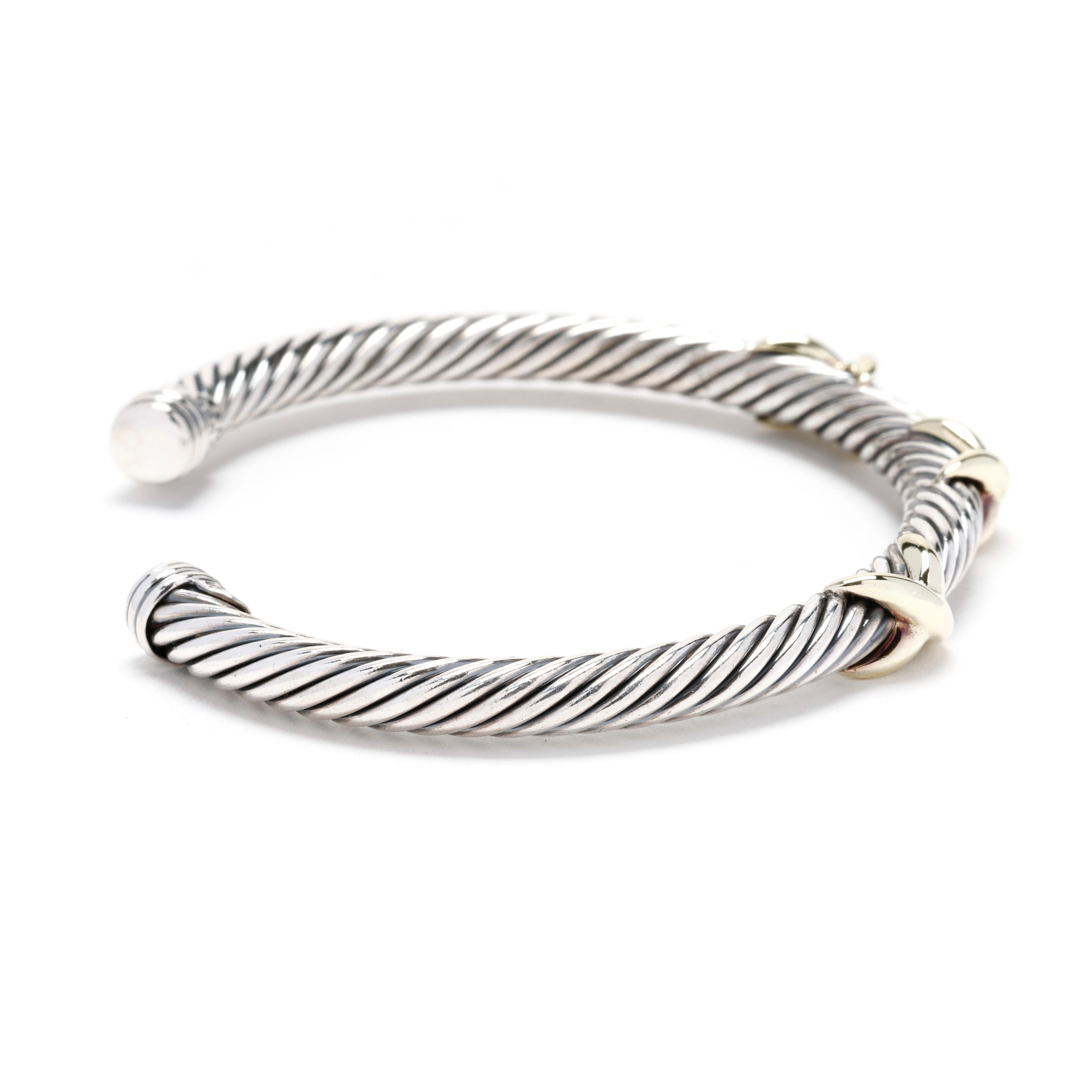 A David Yurman sterling silver 14 karat yellow gold and sterling silver triple X cable cuff bracelet. This cuff bracelet features a silver cable motif cuff with a gold triple X accent.



Length: 6.25 in.; adjustable



DY Size Medium



Width: 7.1