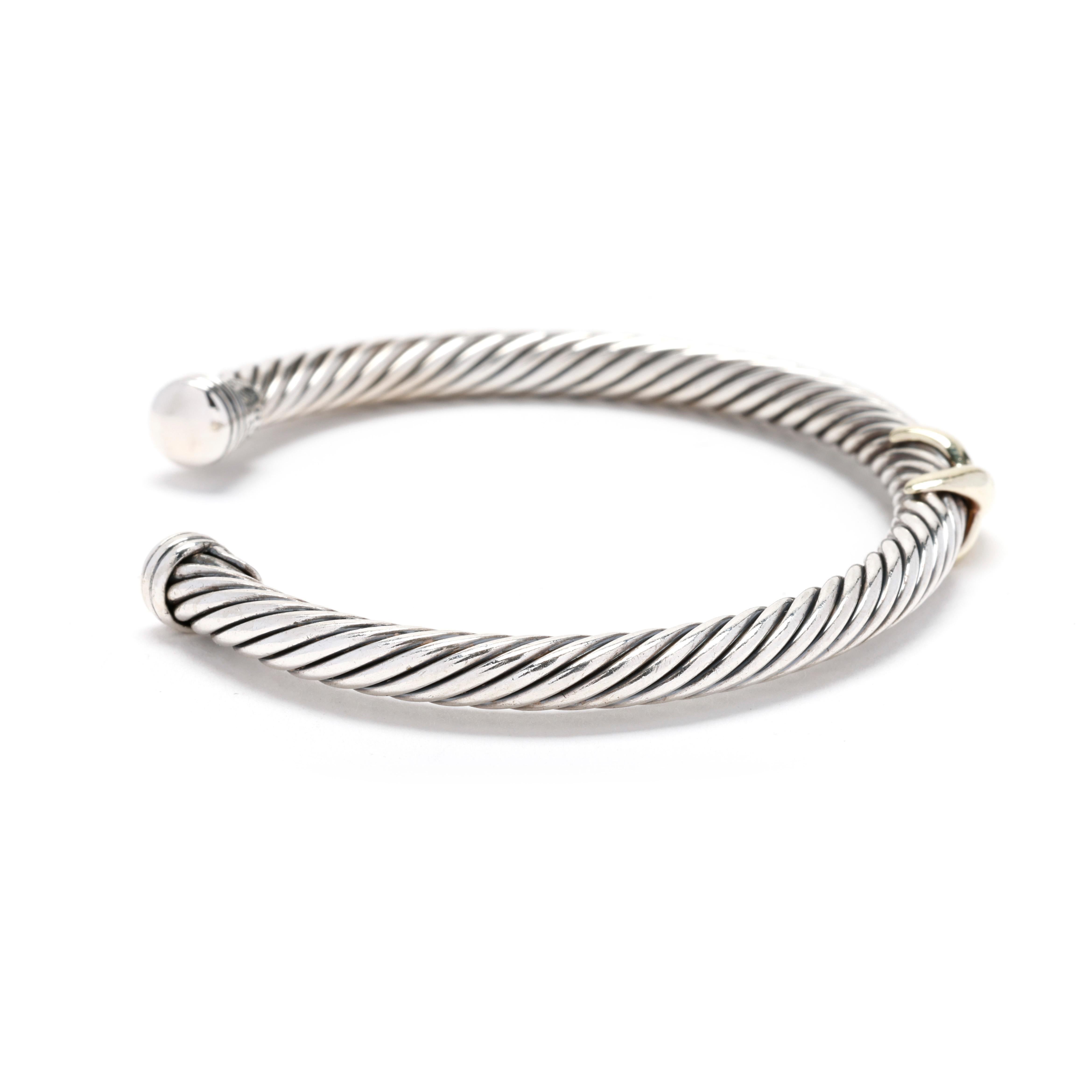 A David Yurman sterling silver 14 karat yellow gold and sterling silver X cable cuff bracelet. This cuff bracelet features a silver cable motif cuff with a gold X accent. Stackable with other cuffs!



Length: 6.25 in.; adjustable



DY Size