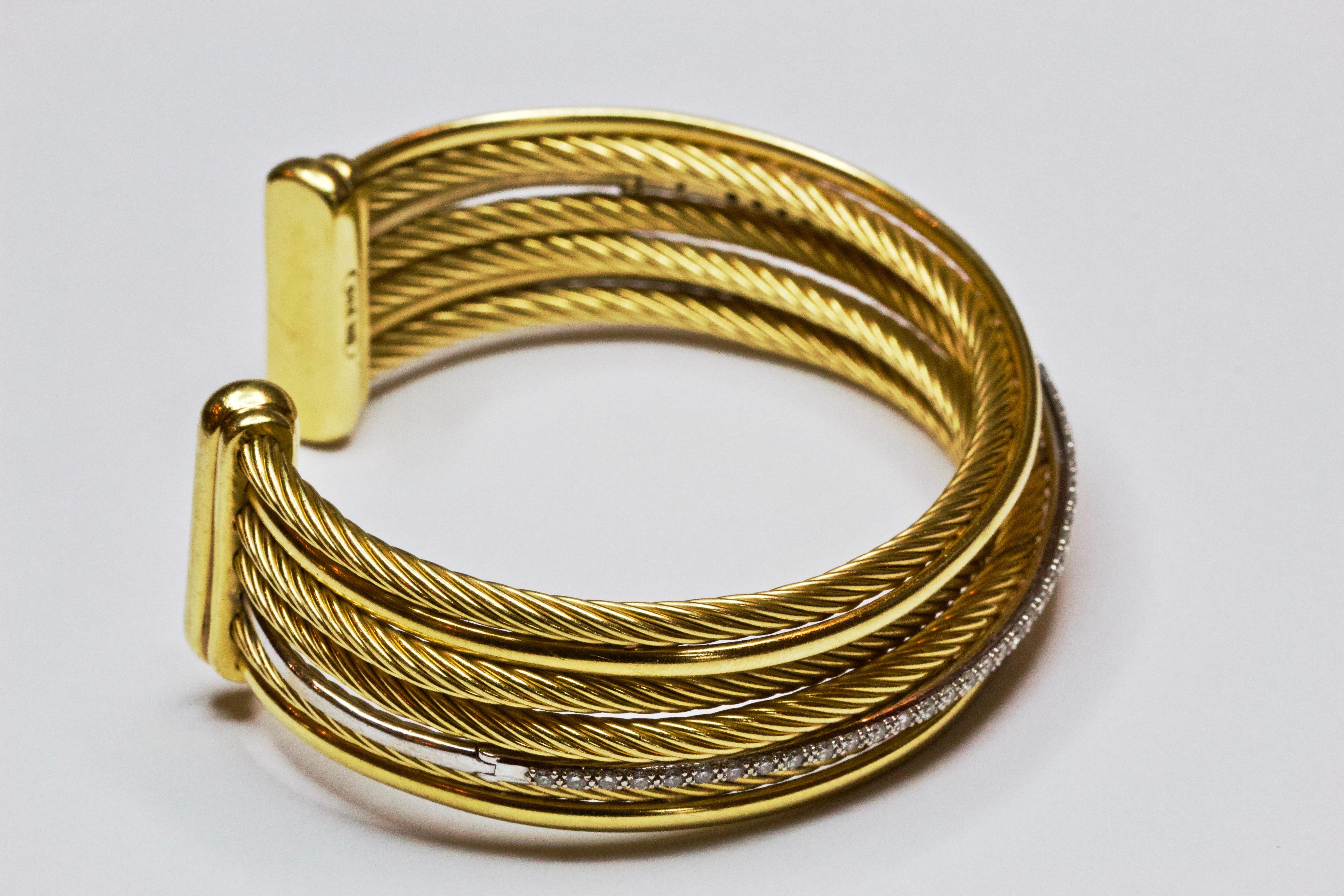 David Yurman’s ‘crossover’ collection focuses on the purity of form and material with each piece being crafted entirely of smooth or Cabled fine metal. Fashioned in 18 carat yellow gold , this bold cuff from David Yurman features multi rows of