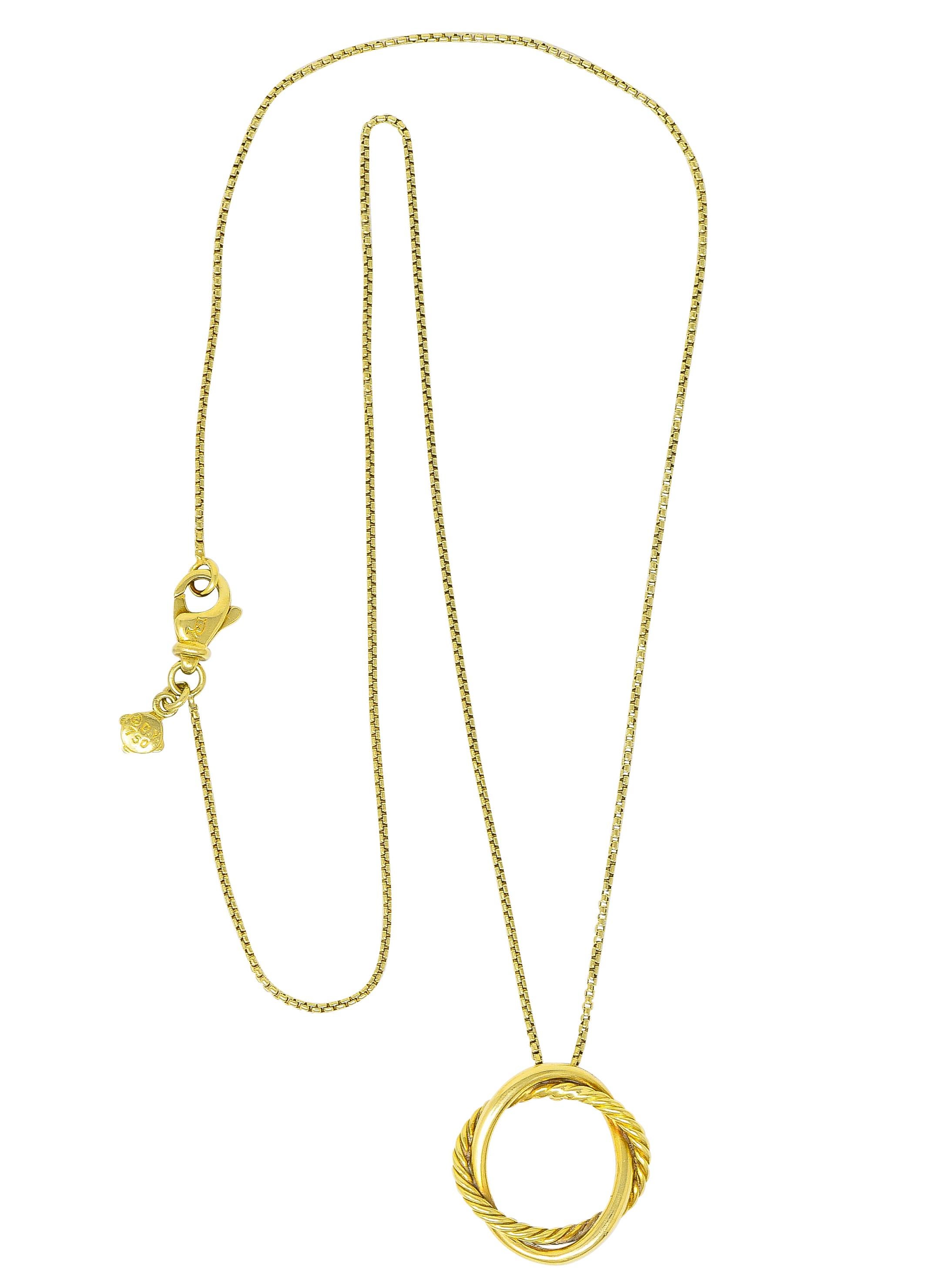 Pendant is designed as two intertwined circles

One is polished gold while the other is the iconic twisted cable motif

Suspending from gold box chain that completes as a stylized lobster clasp

With logo link and maker's mark for David Yurman

Both